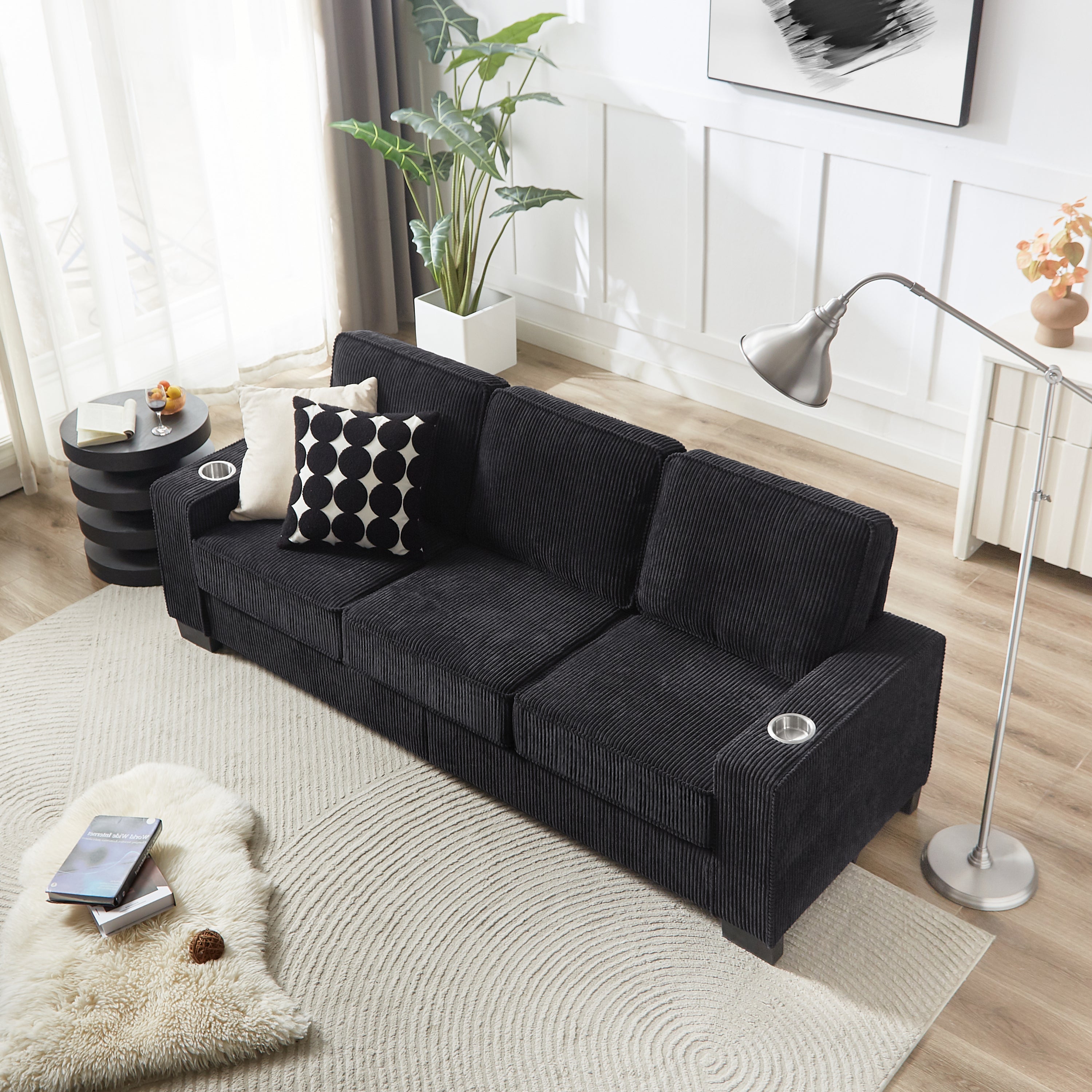 Black corduroy couch wide-wale fabric texture close-up