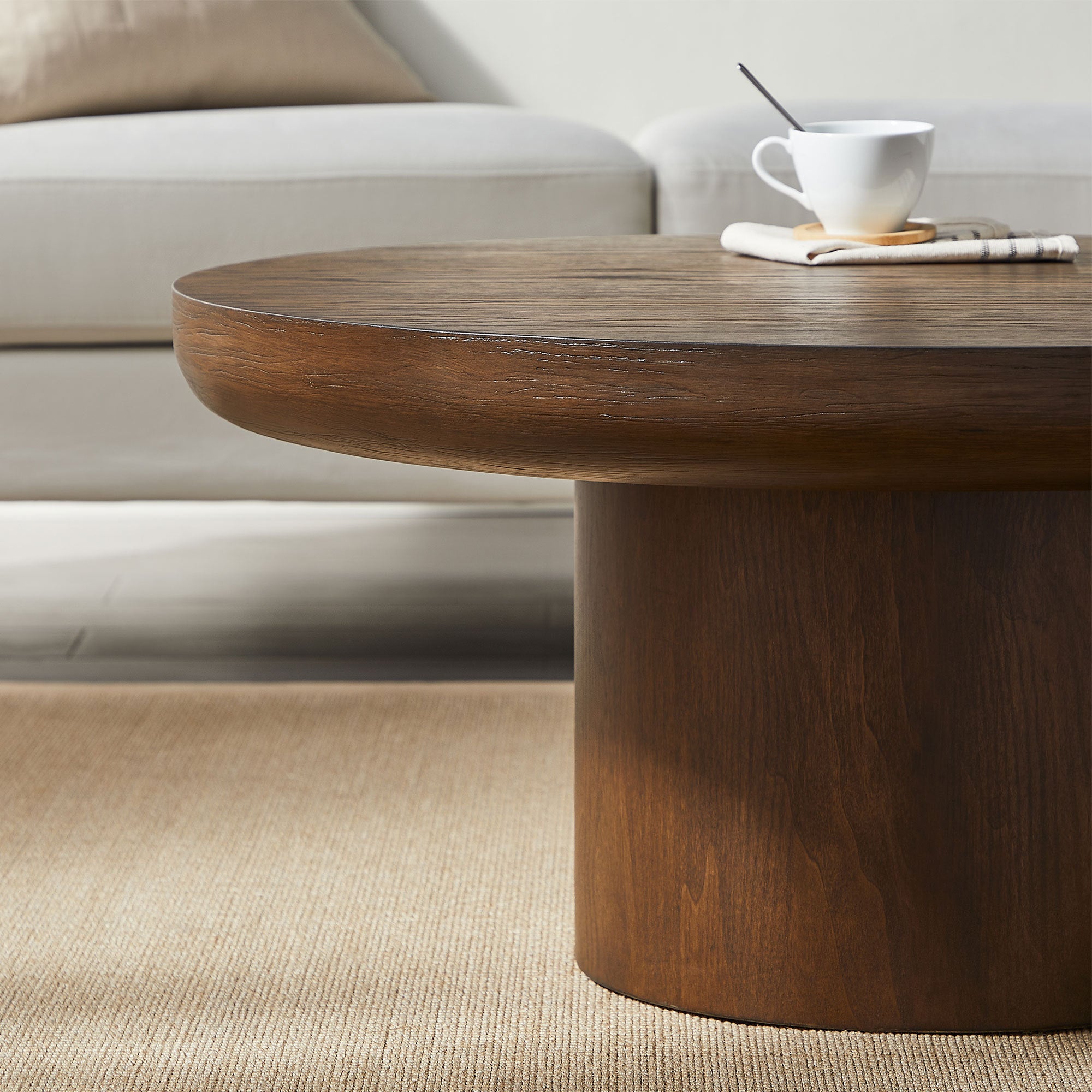 Dark brown round table beside sofa in living room