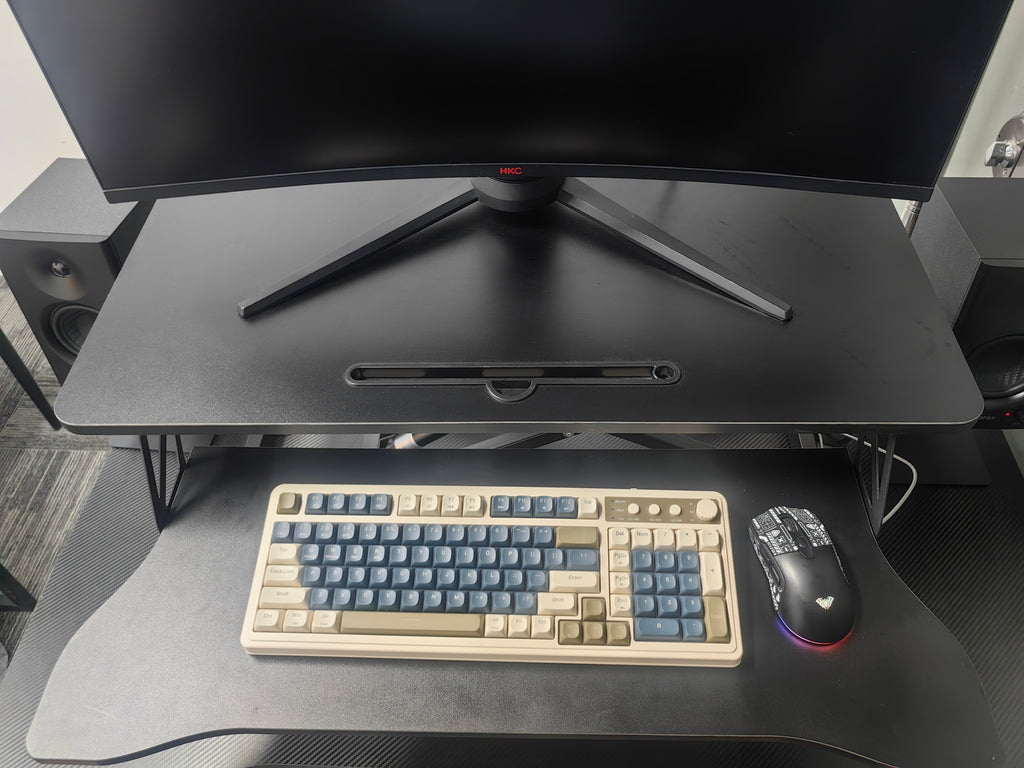 Black sit to stand converter side profile on existing desk