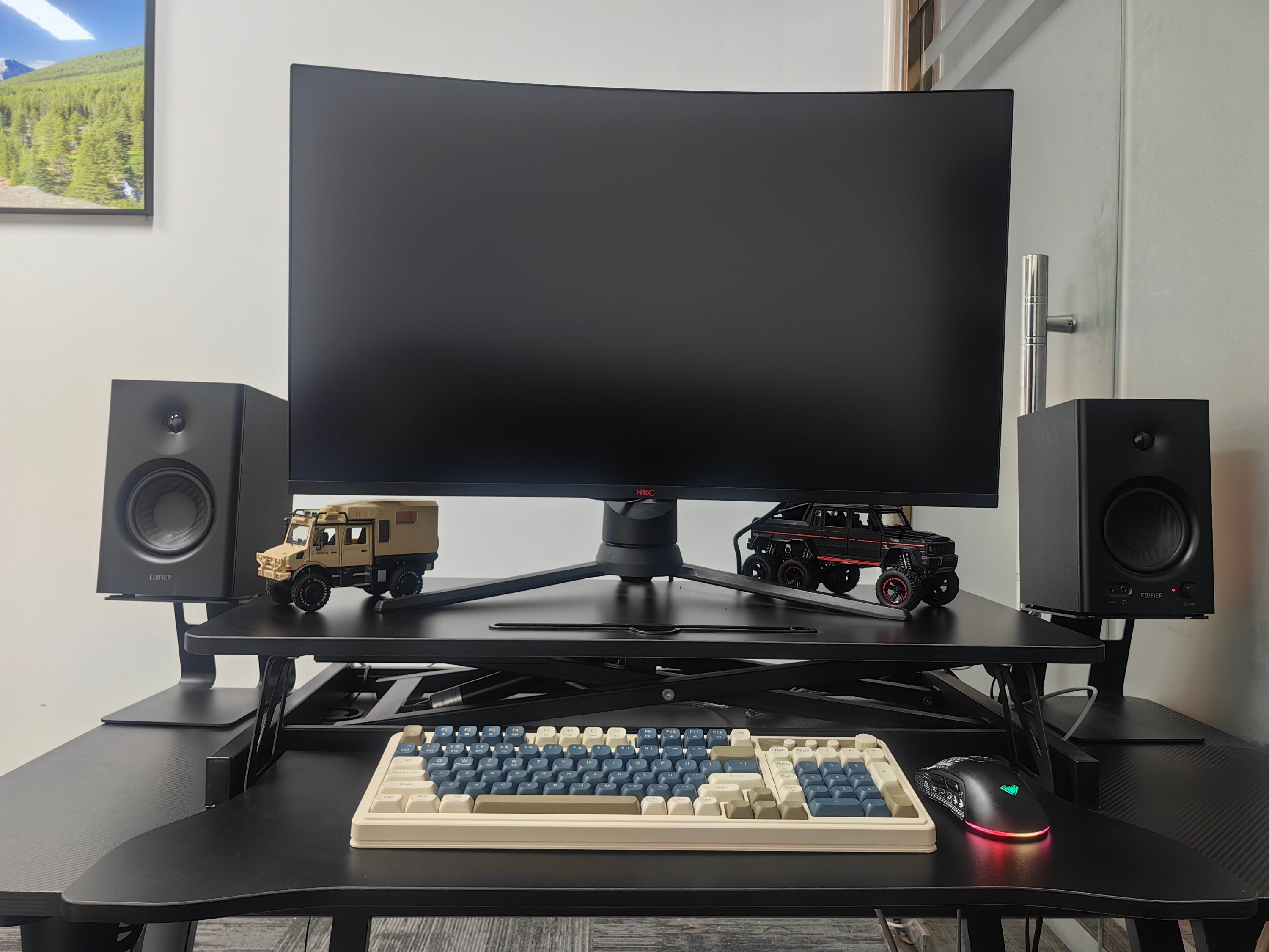 Sit to stand workstation with keyboard tray tucked under desktop