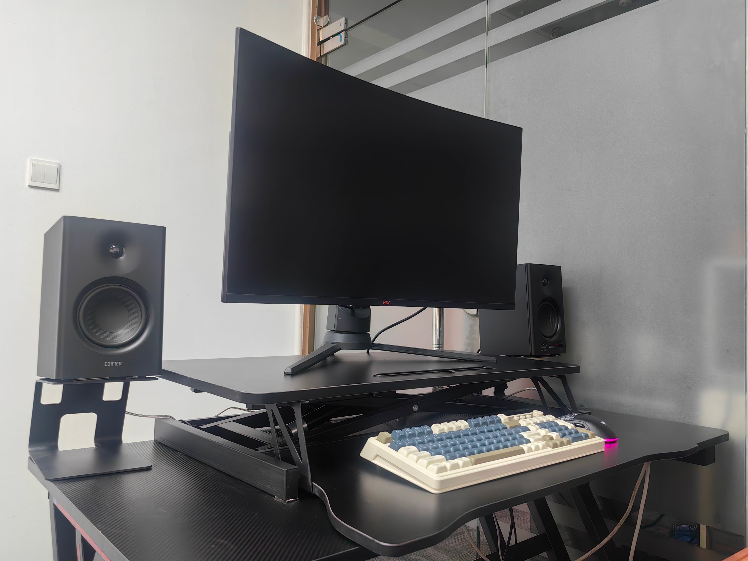 Black desk riser dual monitor setup on home office desk