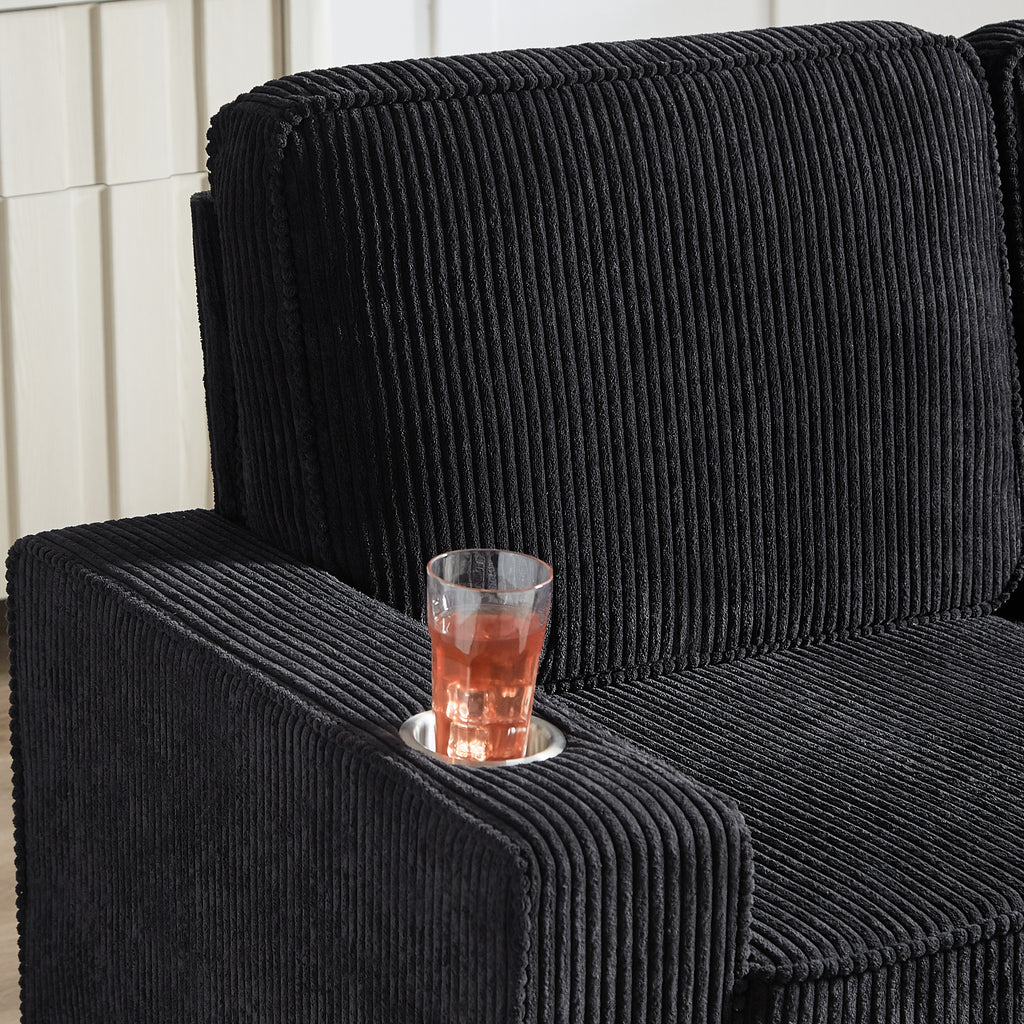 Black corduroy 3-seater sofa with polka-dot and cream throw pillows