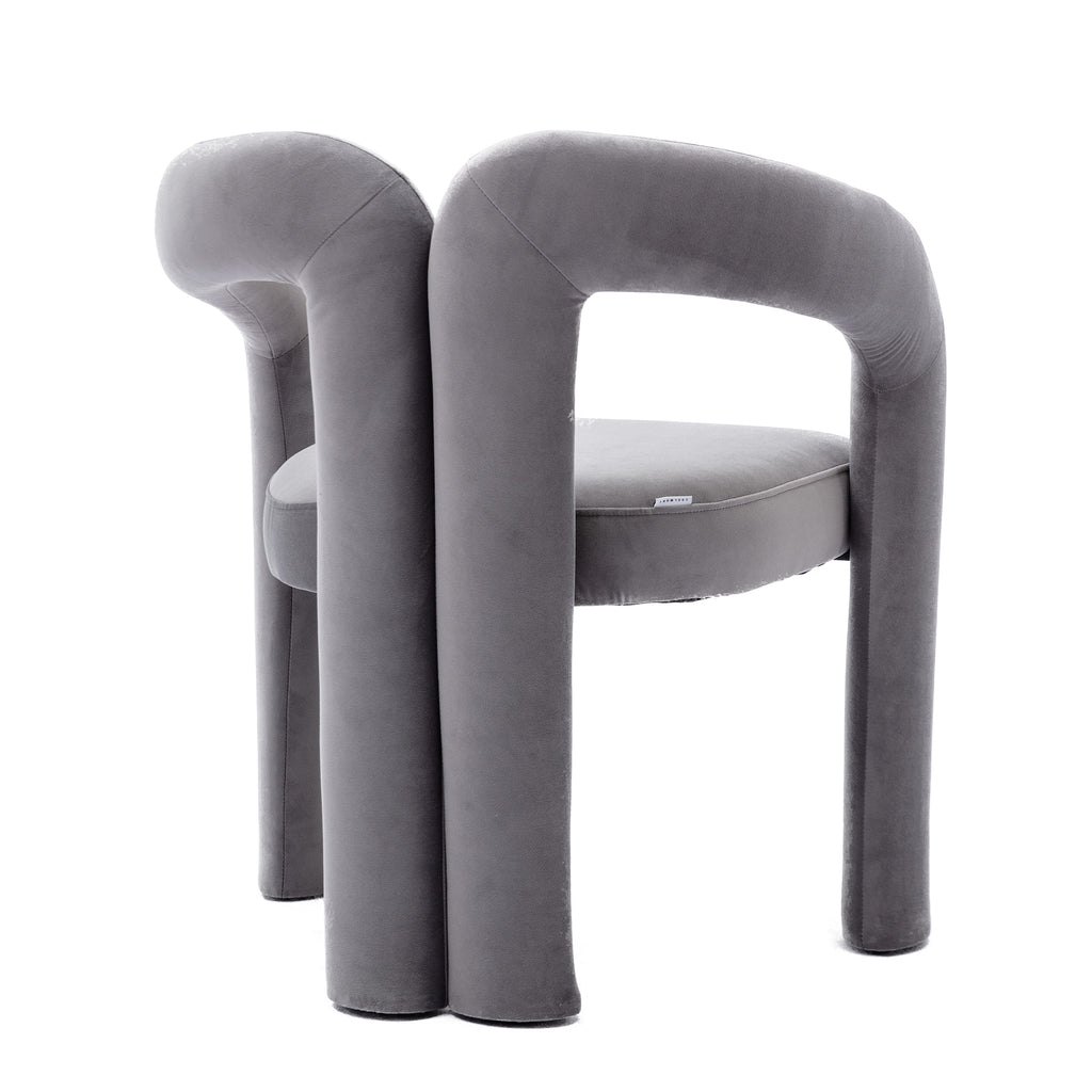 Two gray velvet dining chairs styled at dining table