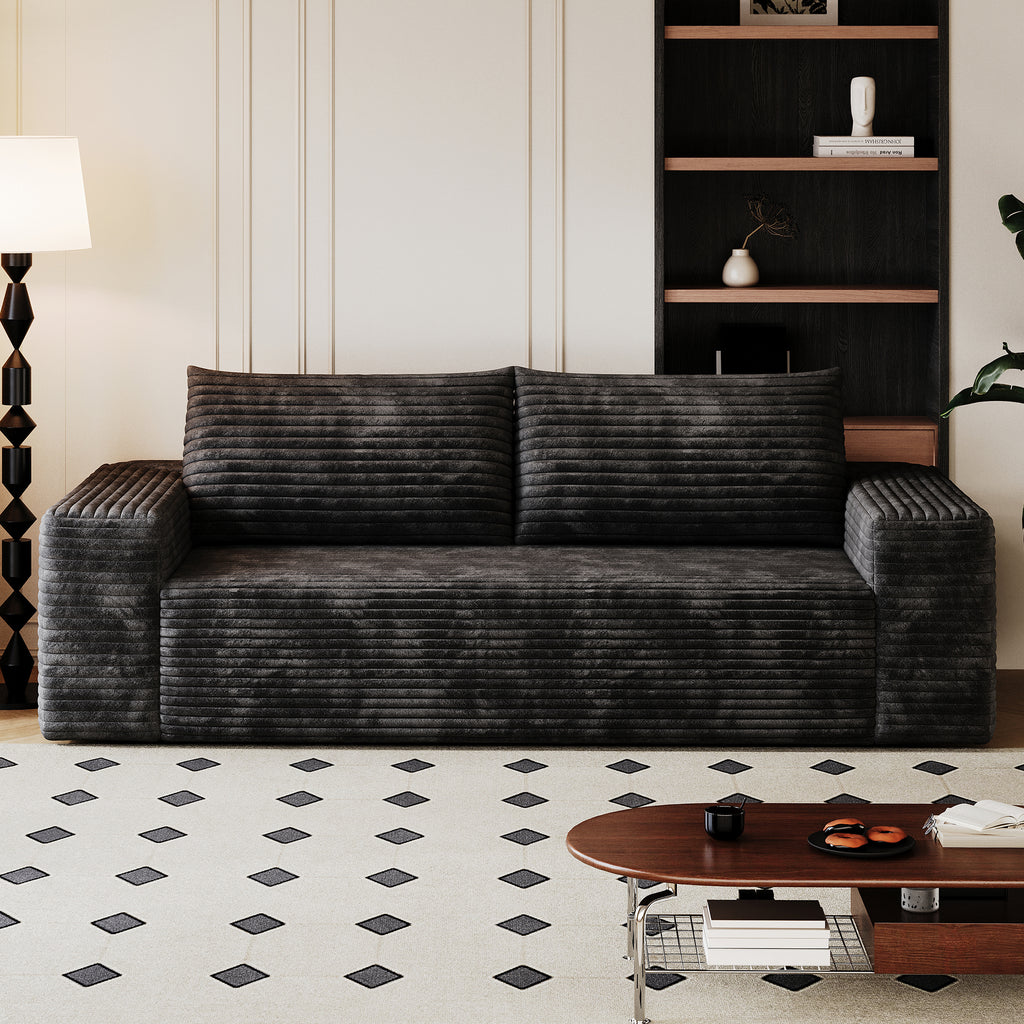 Black corduroy sofa seating area and cushions
