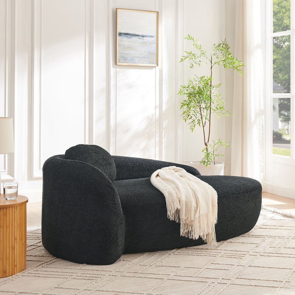 Black oval lounge chair in living room corner setting