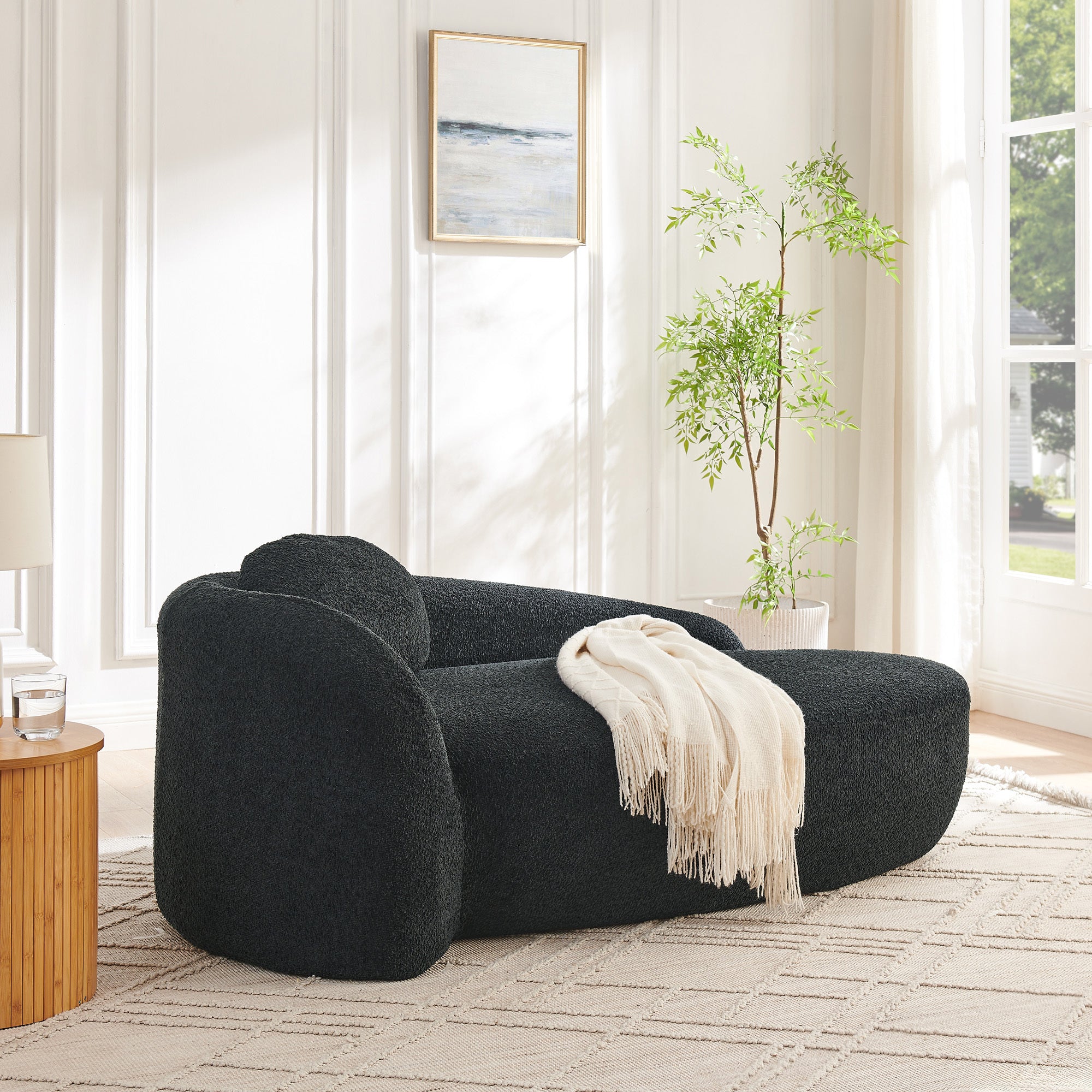 Black oval lounge chair in living room corner setting