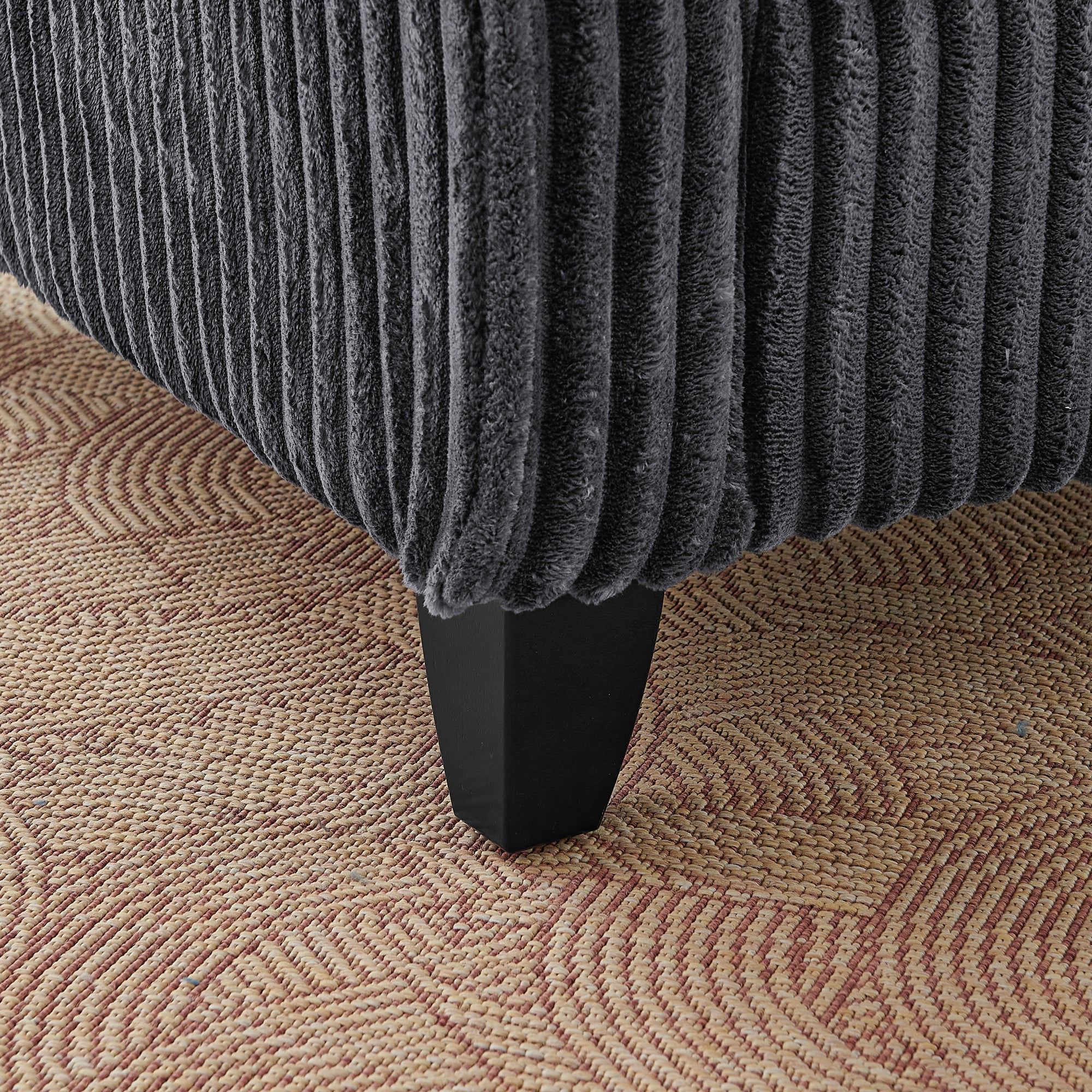 Ergonomic backrest on gray corduroy tufted lounge chair