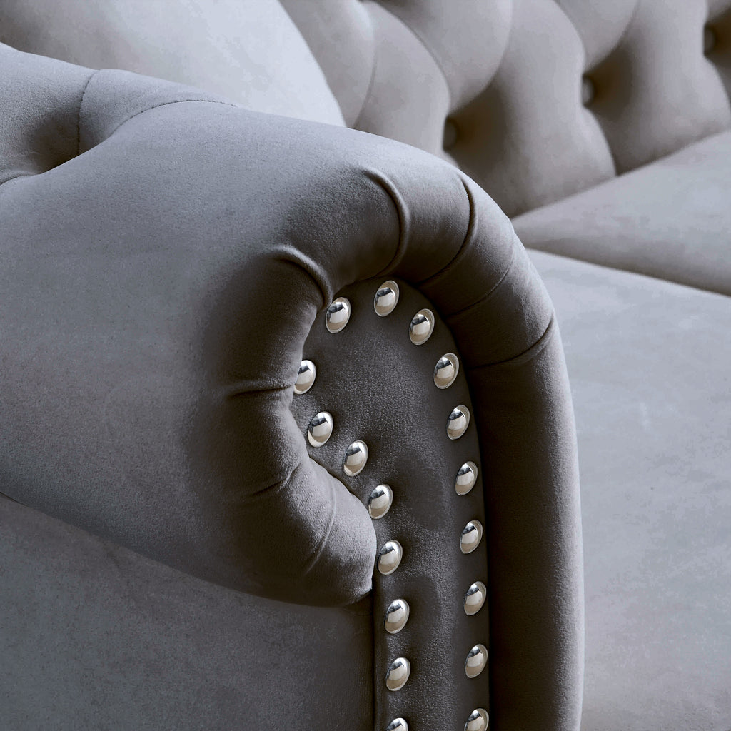Grey Chesterfield sofa in bedroom or office setting