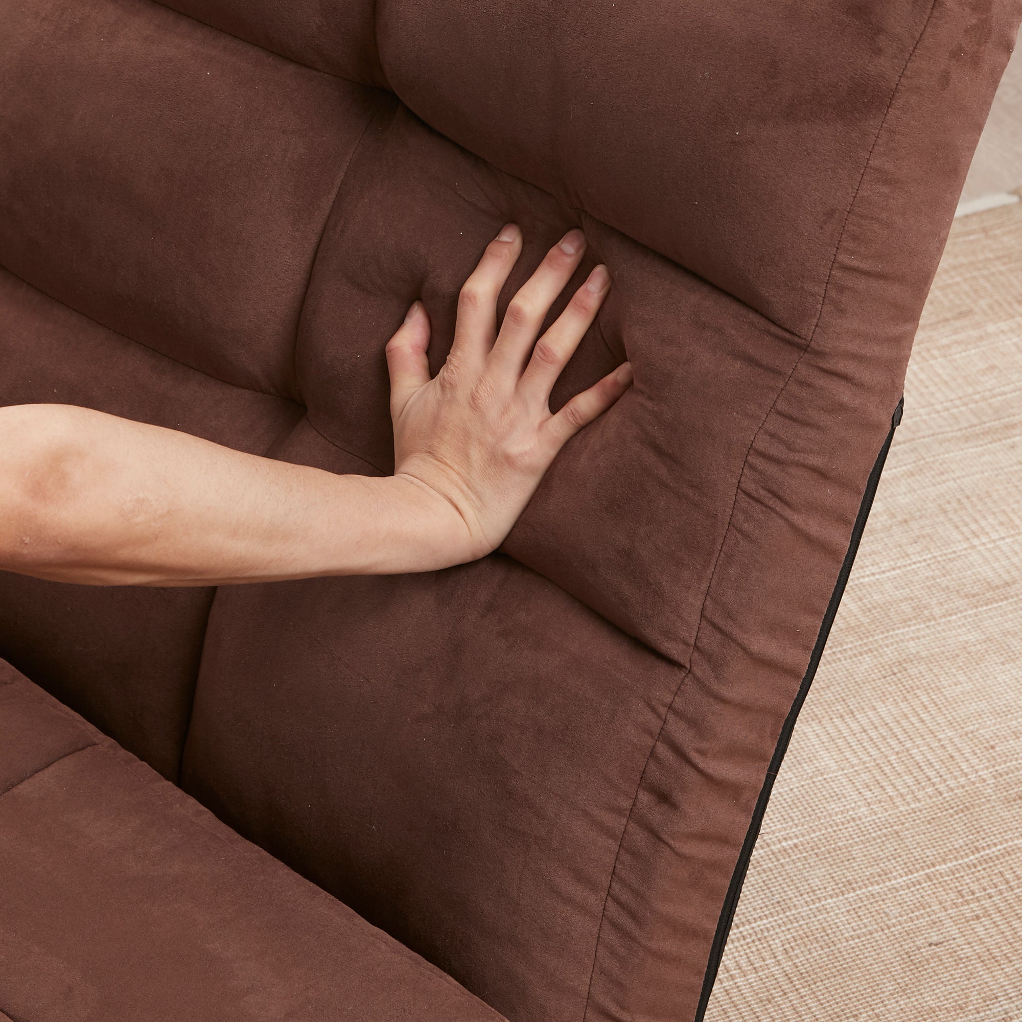 Brown adjustable floor couch in dorm room