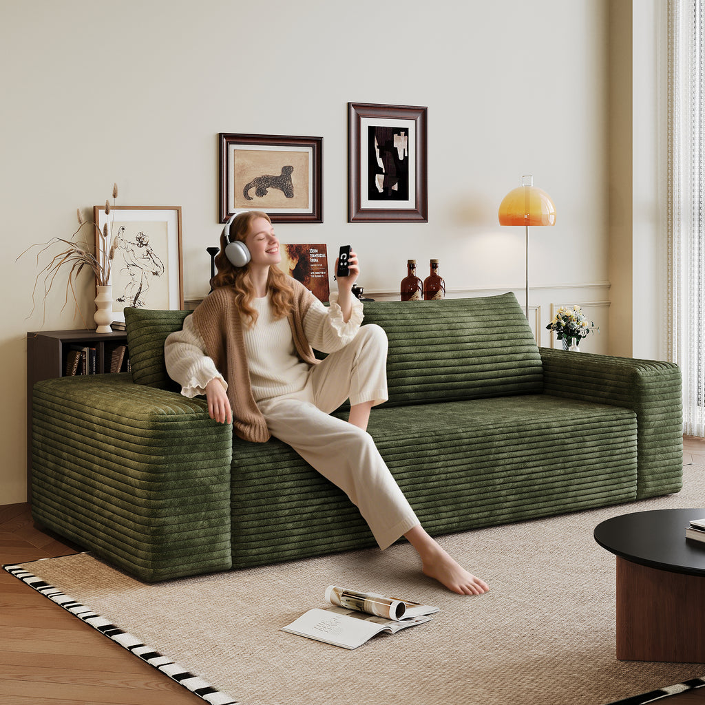 Green corduroy sofa seating area and cushions