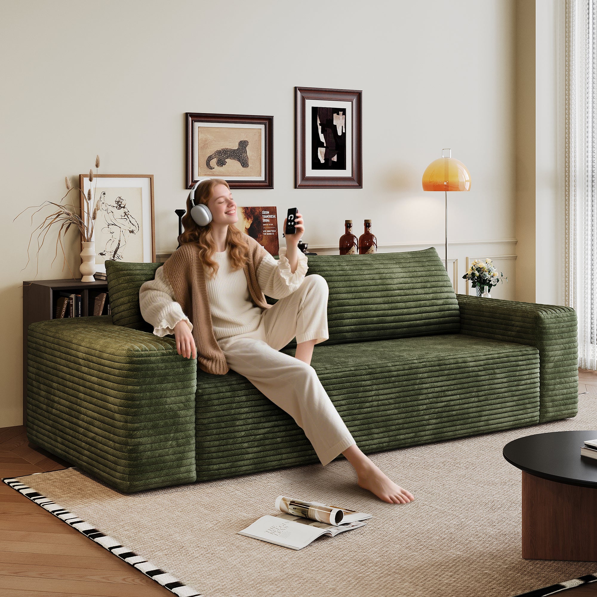 Green corduroy sofa seating area and cushions