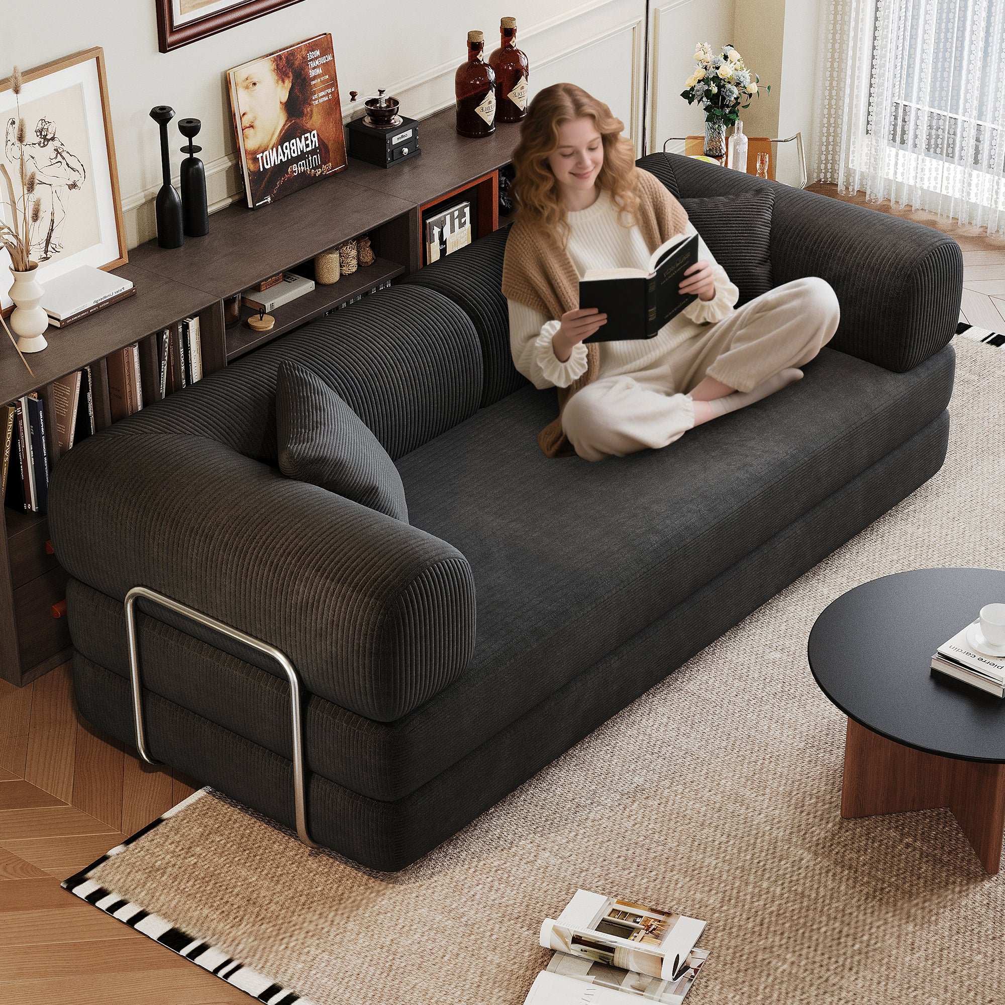Black corduroy convertible sofa in living room setting