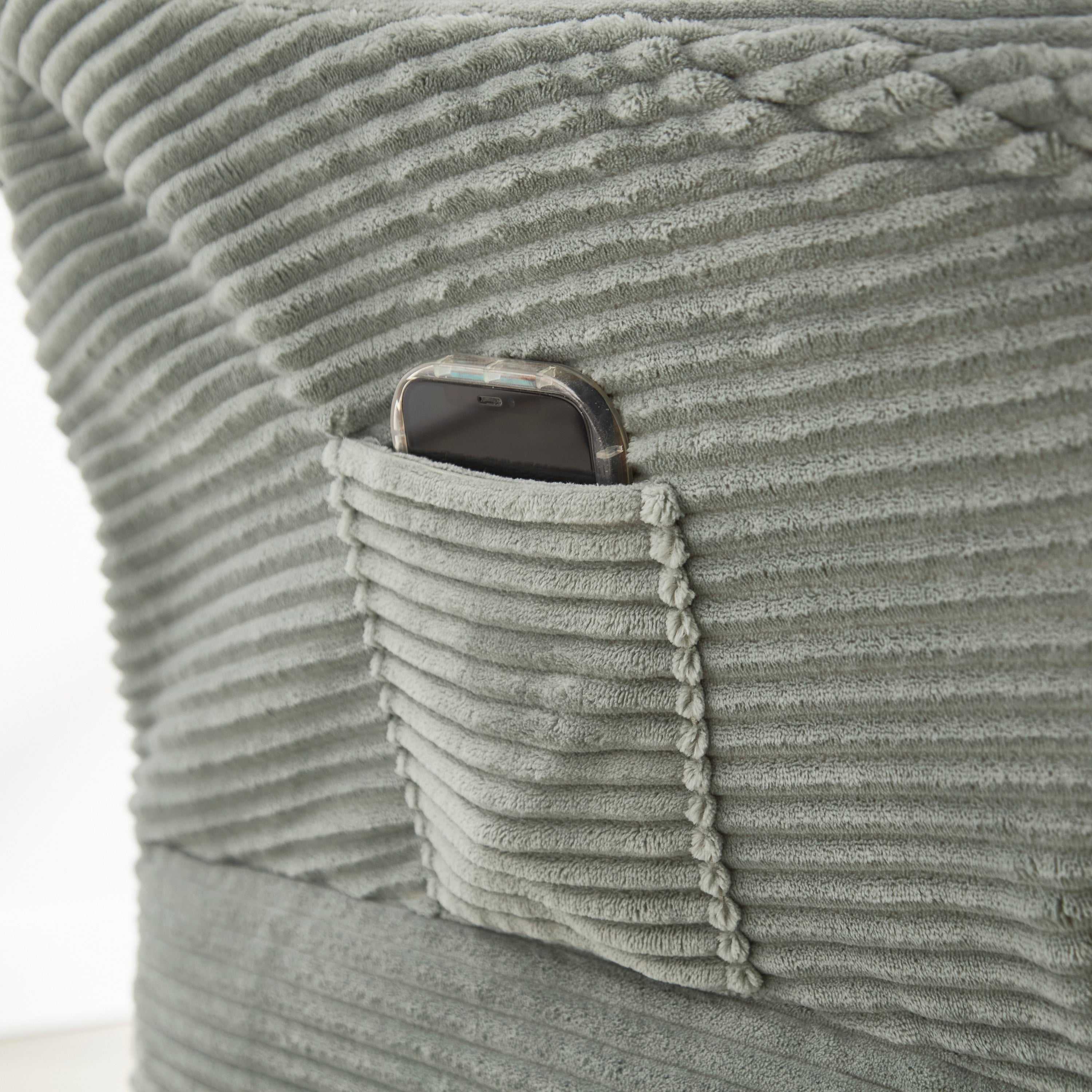 Light green accent chair with side storage pocket