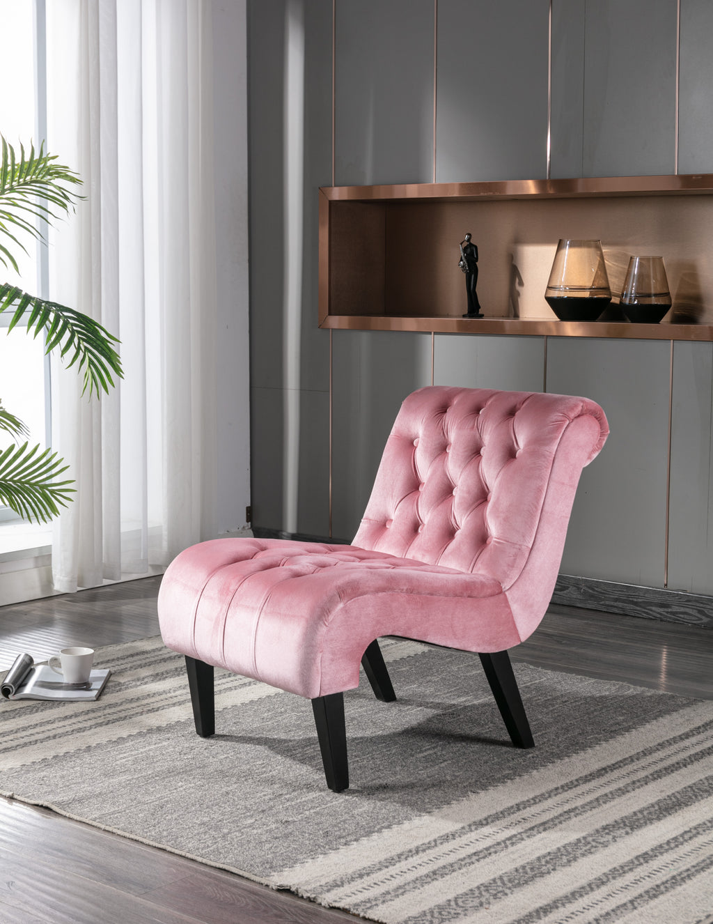 Pink accent chair with wood legs — angle view