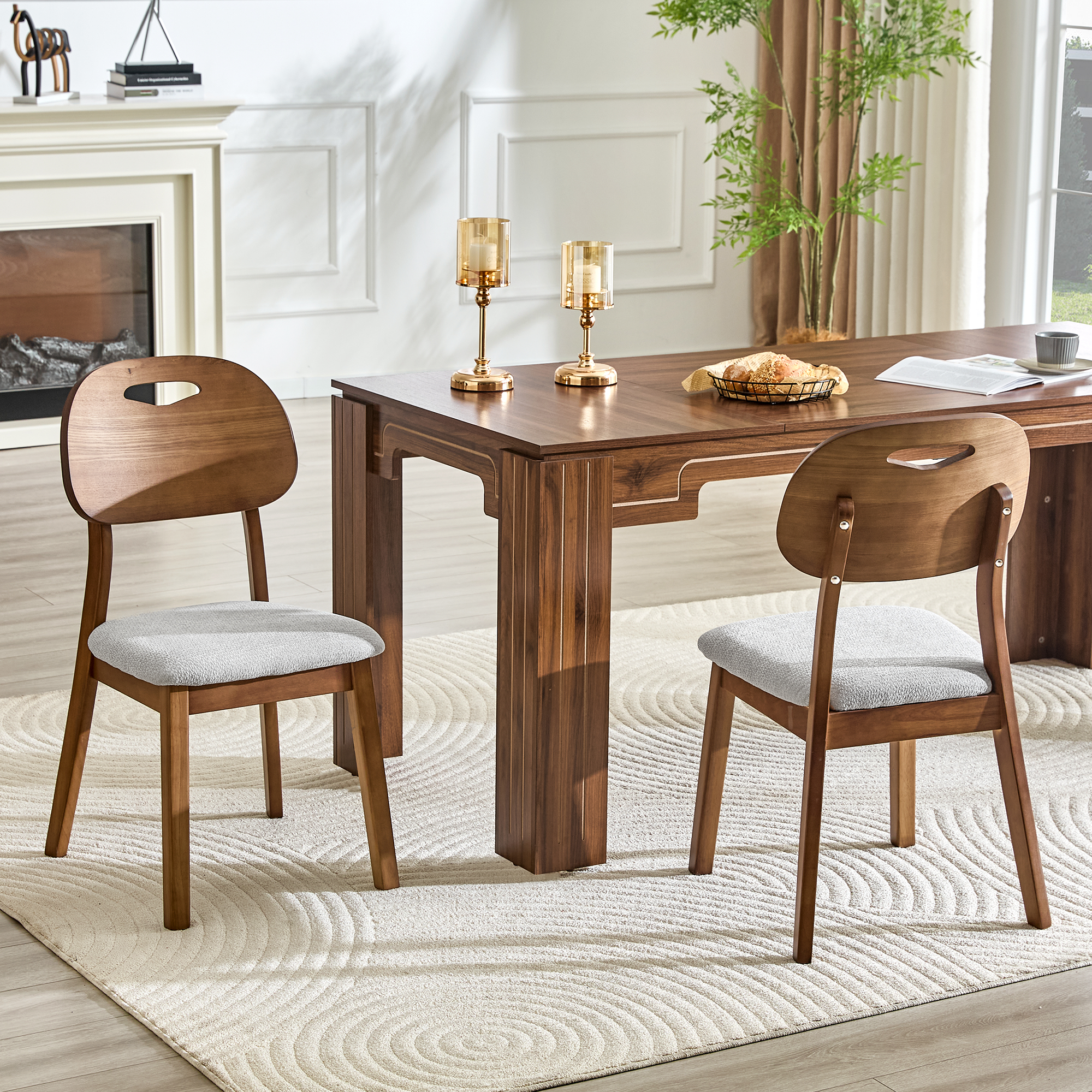 2 walnut colored solid wood dining chairs, with gray breathable fabric wrapped cushions and hollowed out backrests, suitable for home dining.