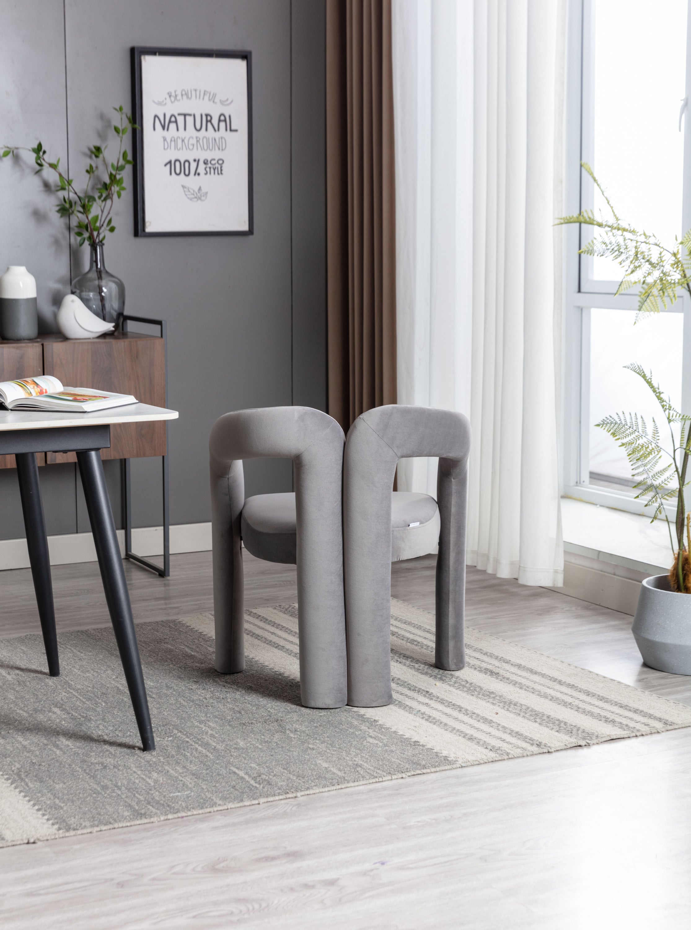 Gray velvet accent chair curved circular backrest detail