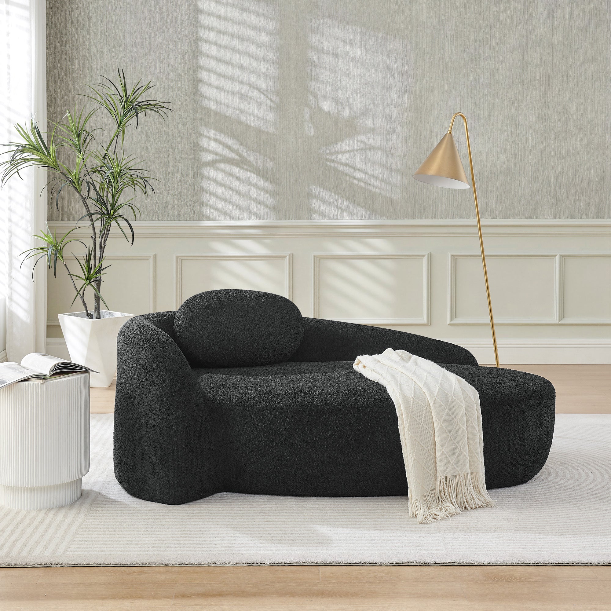 Black bouclé single-seat lounge chair armrest detail
