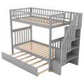 Gray twin-over-twin bunk bed with trundle and storage shelves — front view