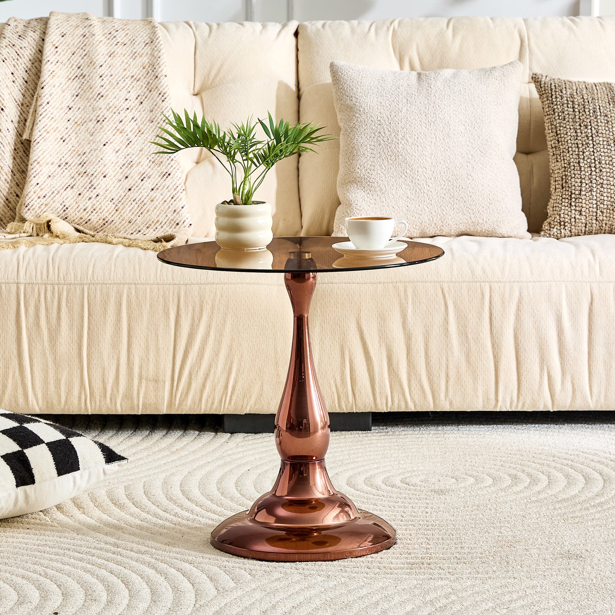 Brown tempered glass round tabletop close-up on rose gold side table