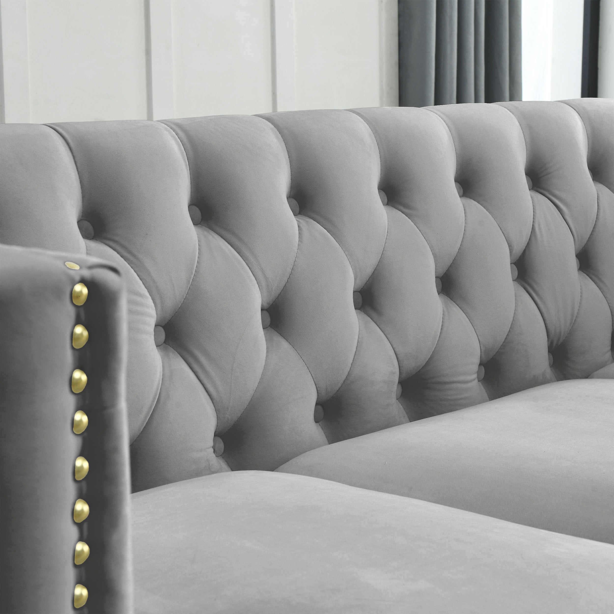 Grey velvet Chesterfield front three-quarter view