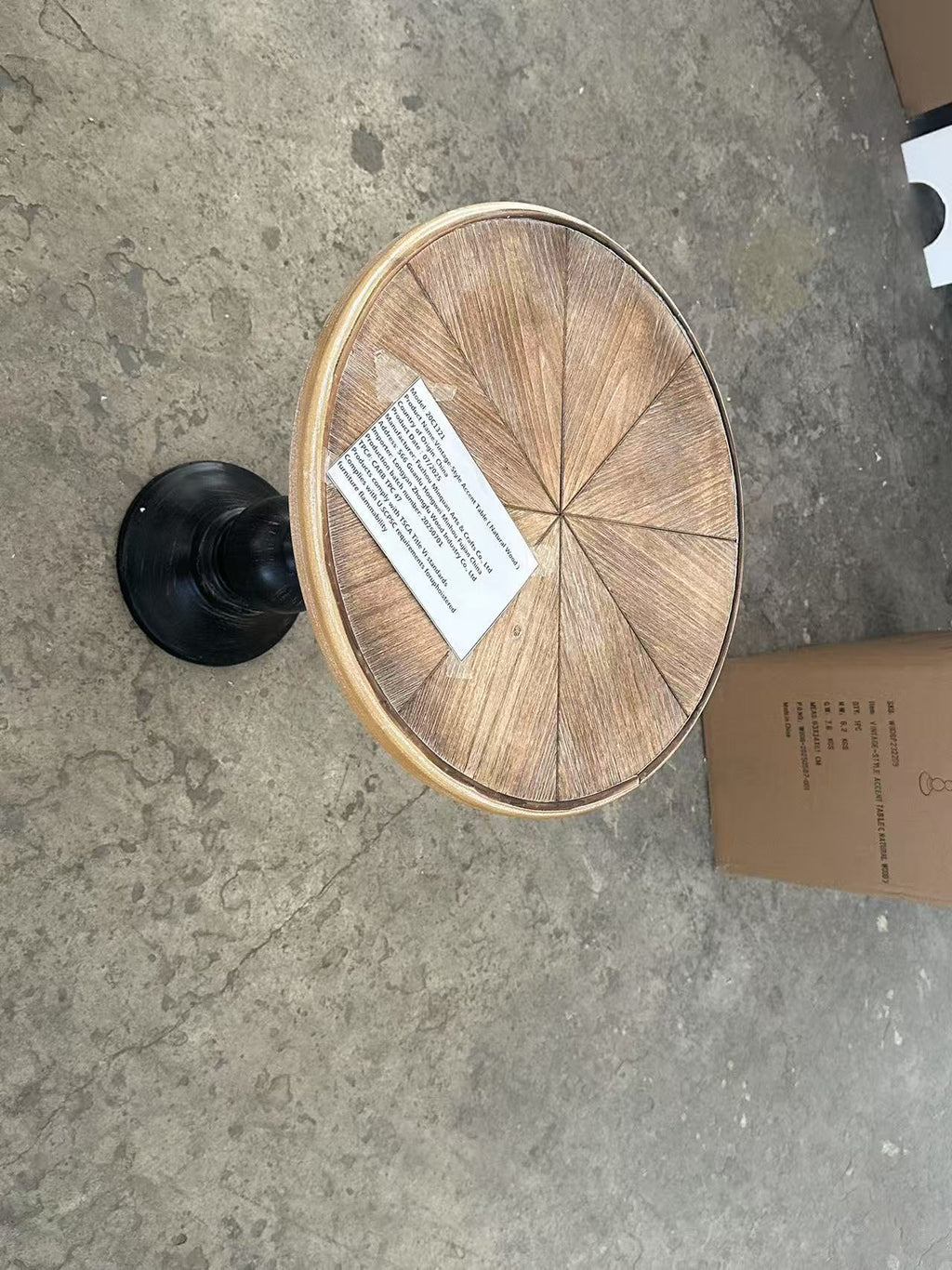 Natural wood round end table in corner setting