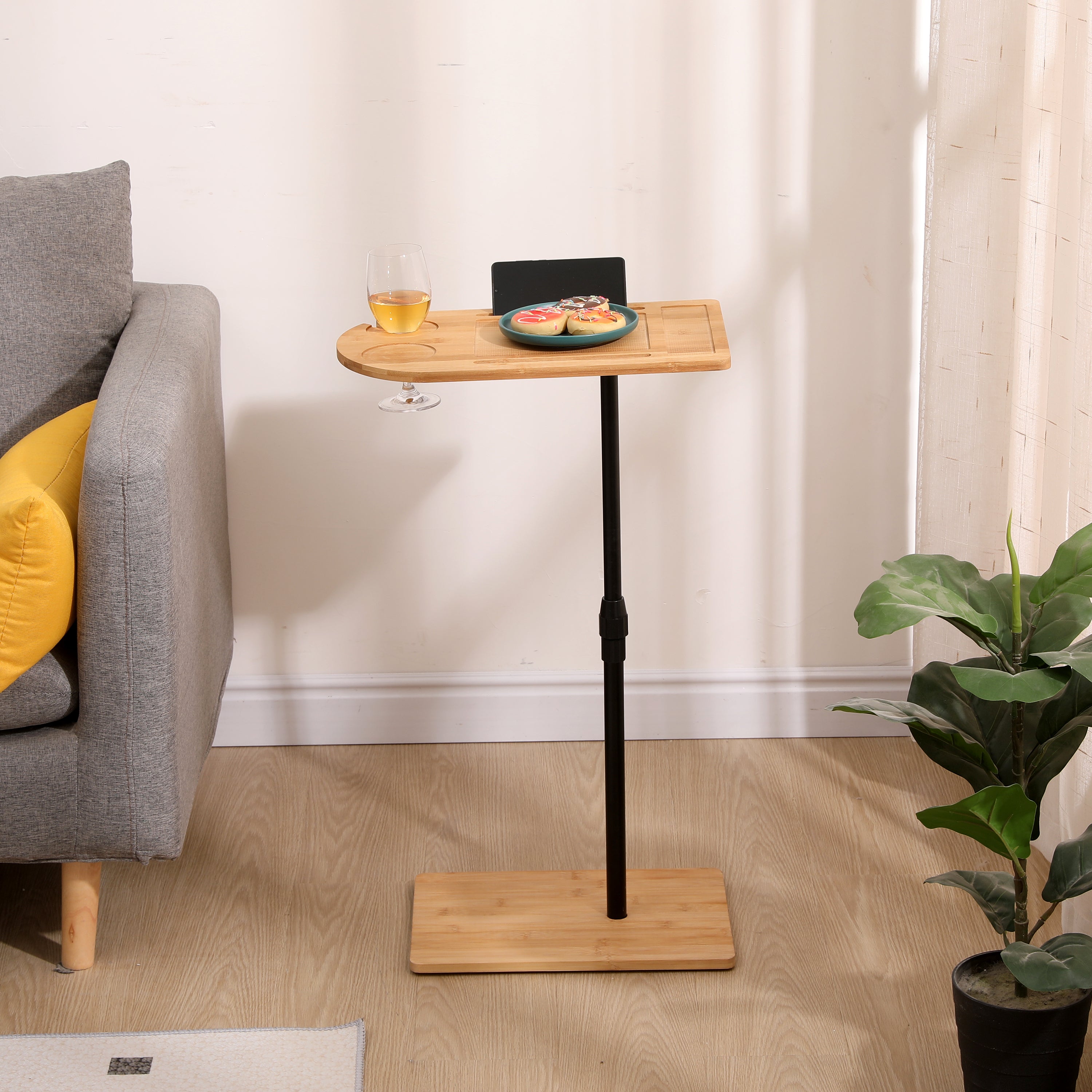 Natural bamboo C-shaped side table beside bed in bedroom