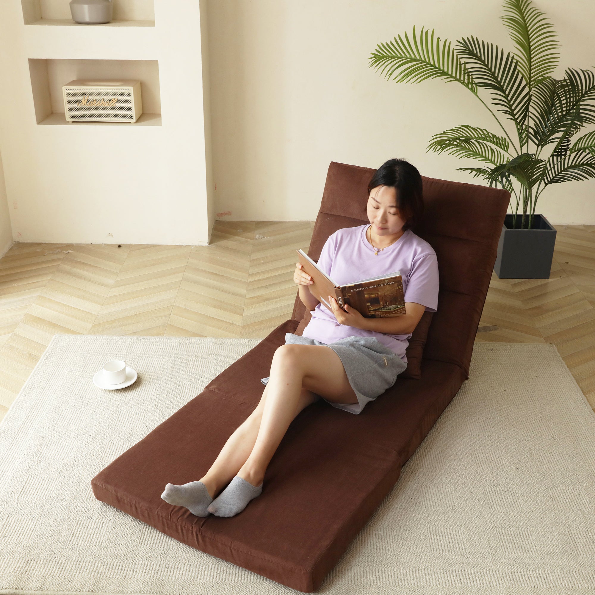Included throw pillow on brown fold-down sofa bed