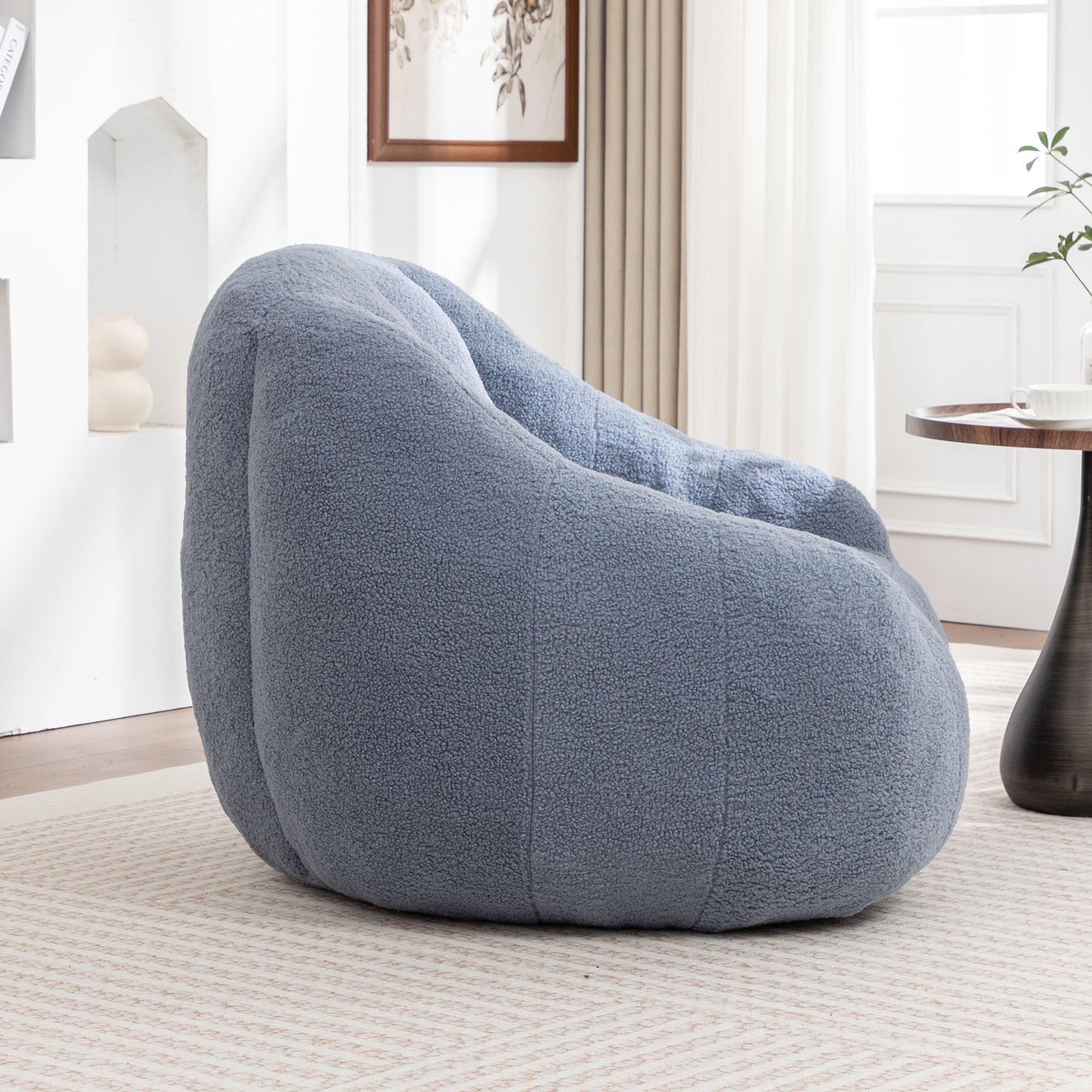 Light blue bean bag chair with armrests side profile