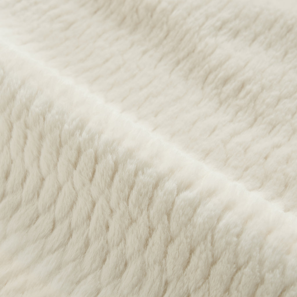 Cream faux fur chair angle view in living room setting