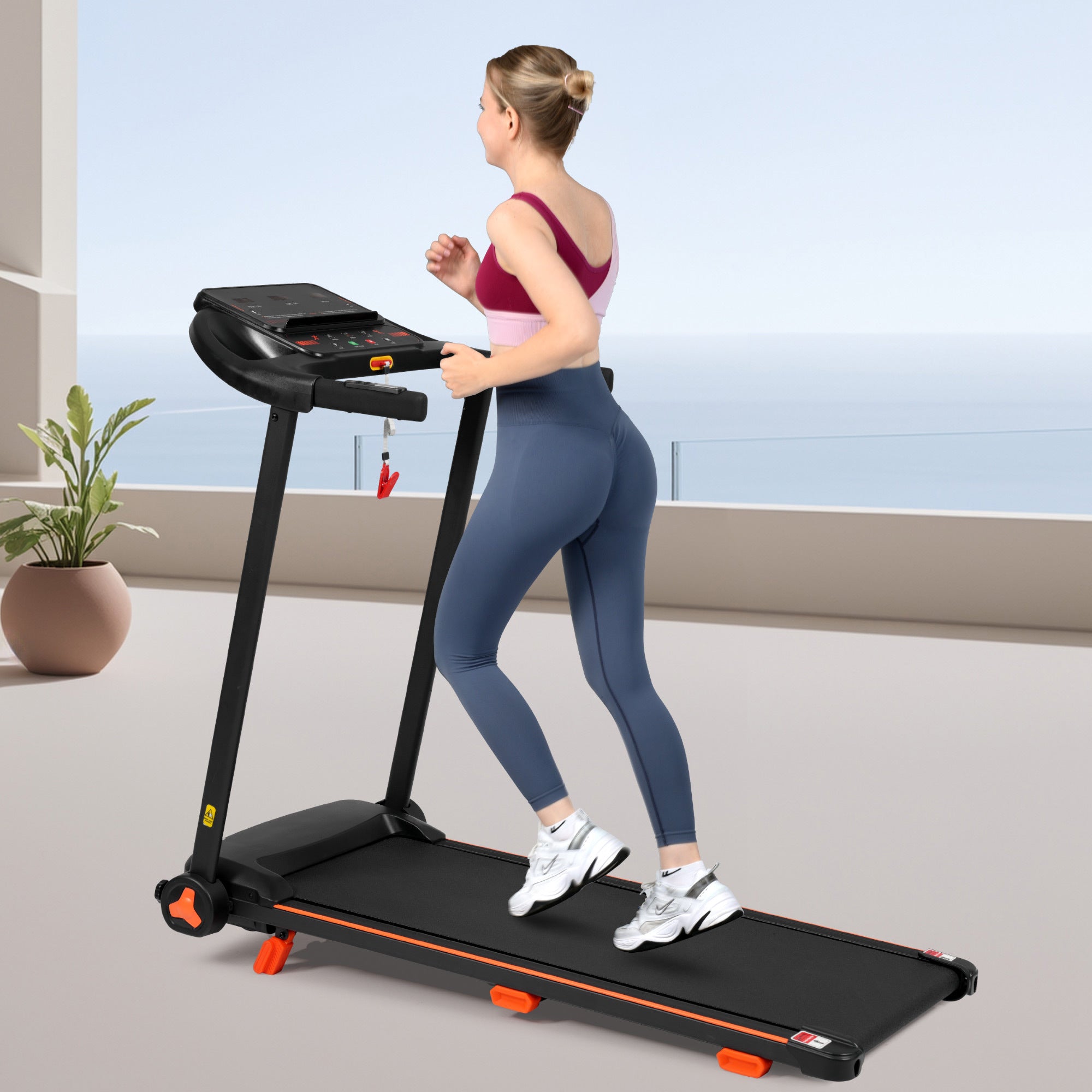 Black treadmill unfolded in home living room setting