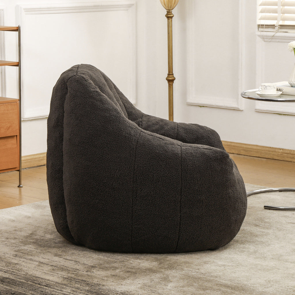 Tufted bean bag sofa chair armrest detail — dark gray