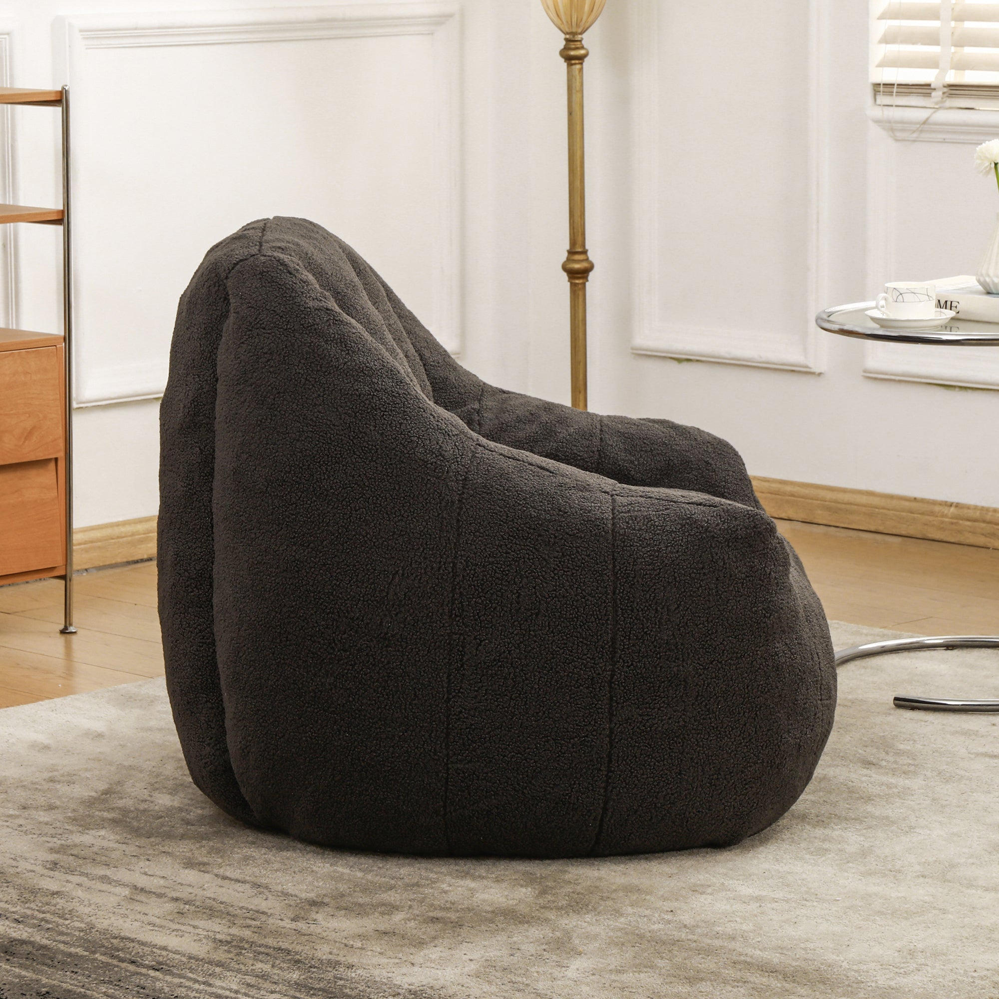Tufted bean bag sofa chair armrest detail — dark gray