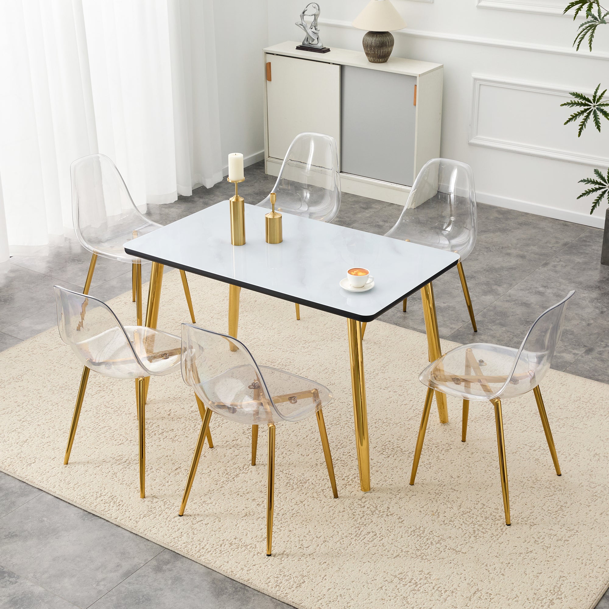Table and chair set.White imitation marble texture glass top + lower black MDF board,golden metal tapered legs.Paired with 6 Transparent Plastic Chairs with Golden Metal Legs.