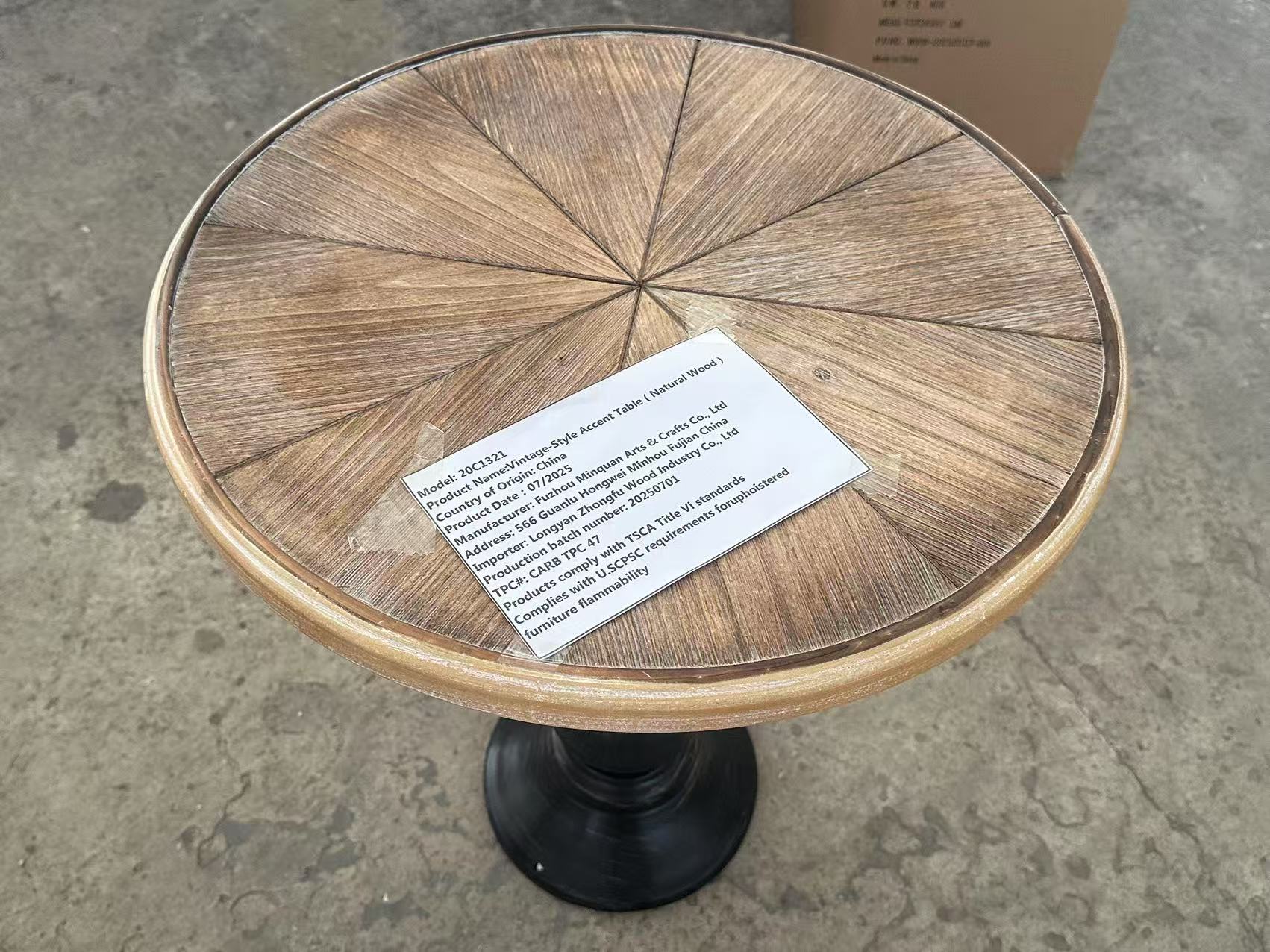 Natural wood round table with black pedestal base