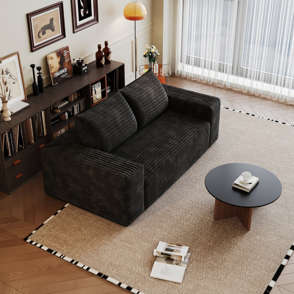 Black loveseat in bedroom setting