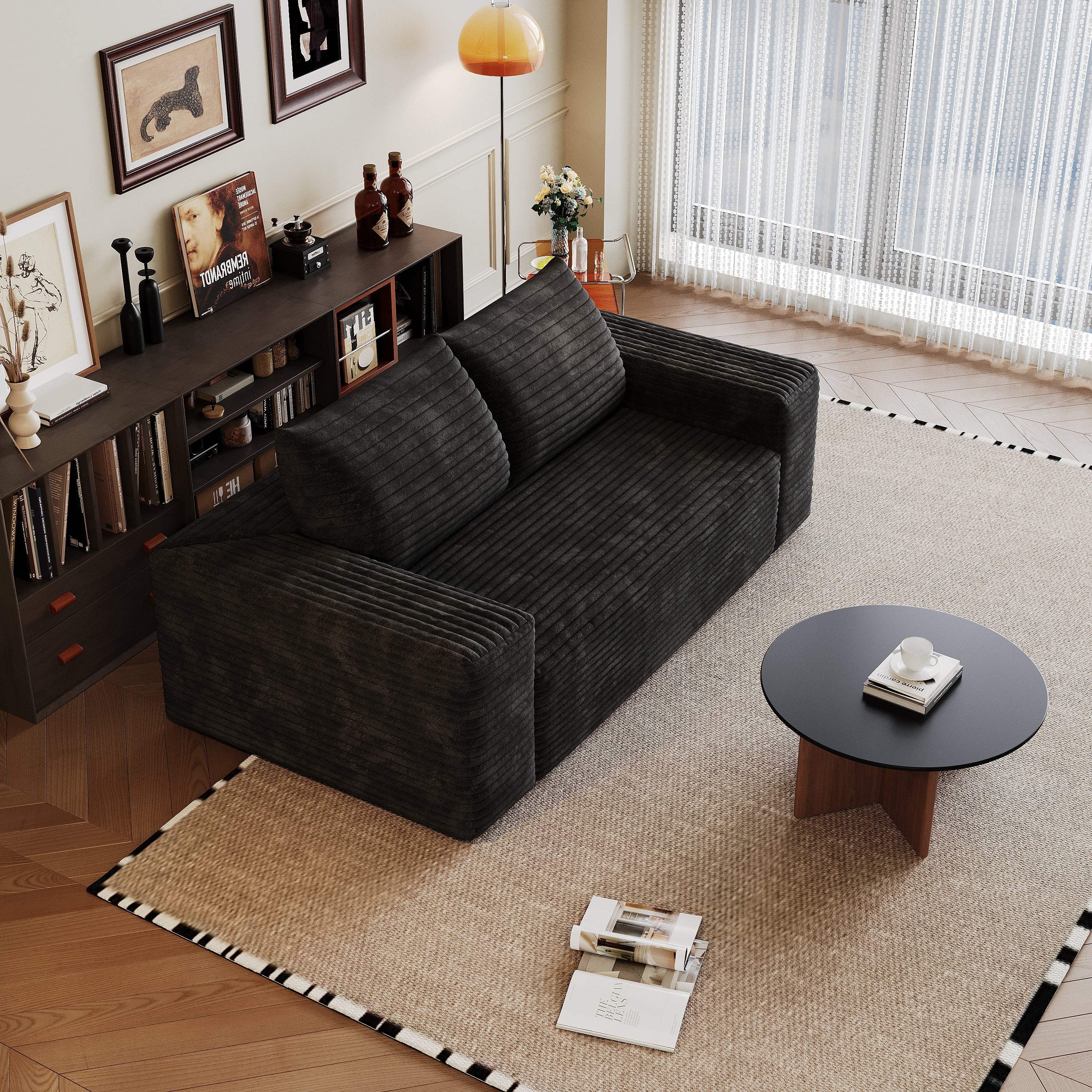 Black loveseat in bedroom setting