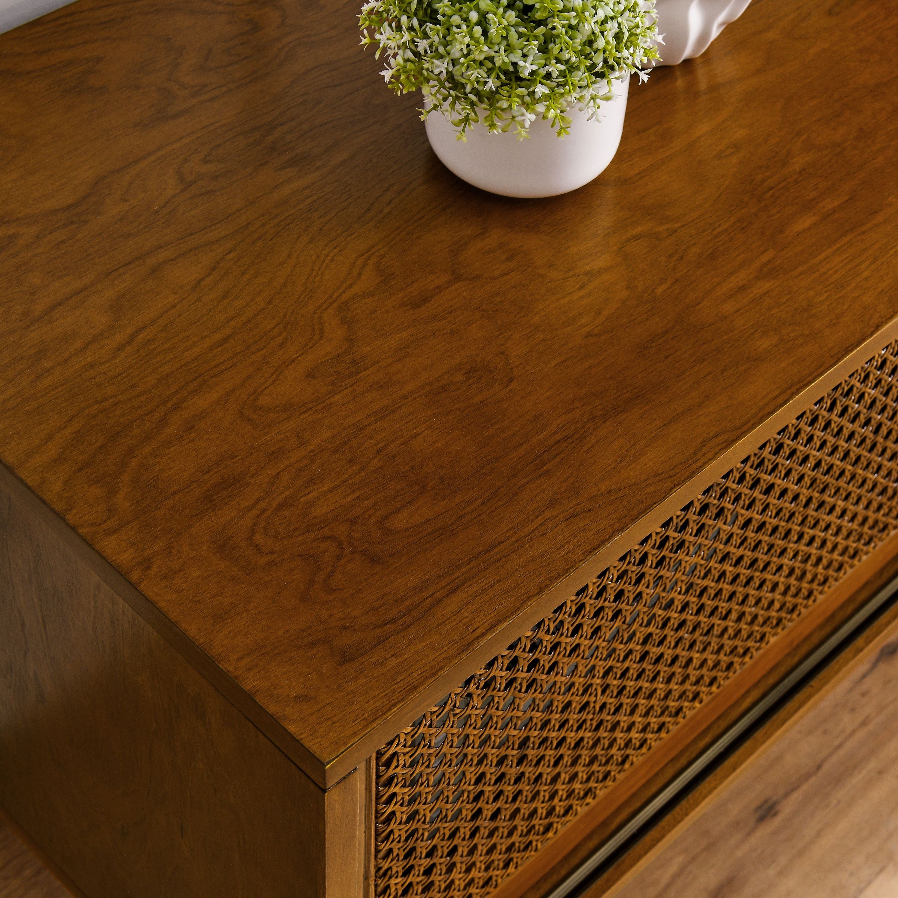 Light wood TV stand with open shelf storage detail