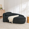 Black bouclé oval lazy lounge chair with pillow — front view