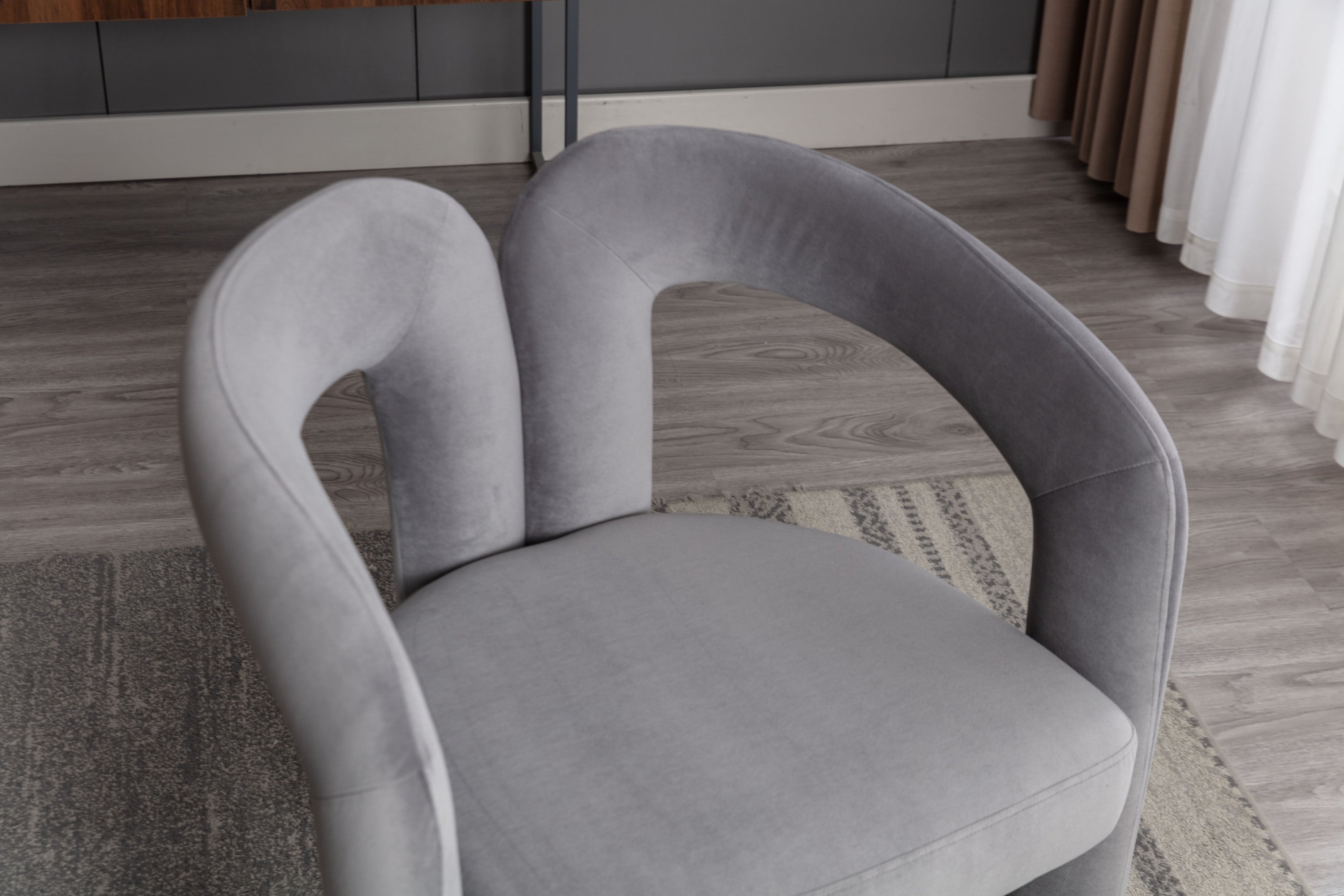High-density foam seat on gray velvet barrel chair