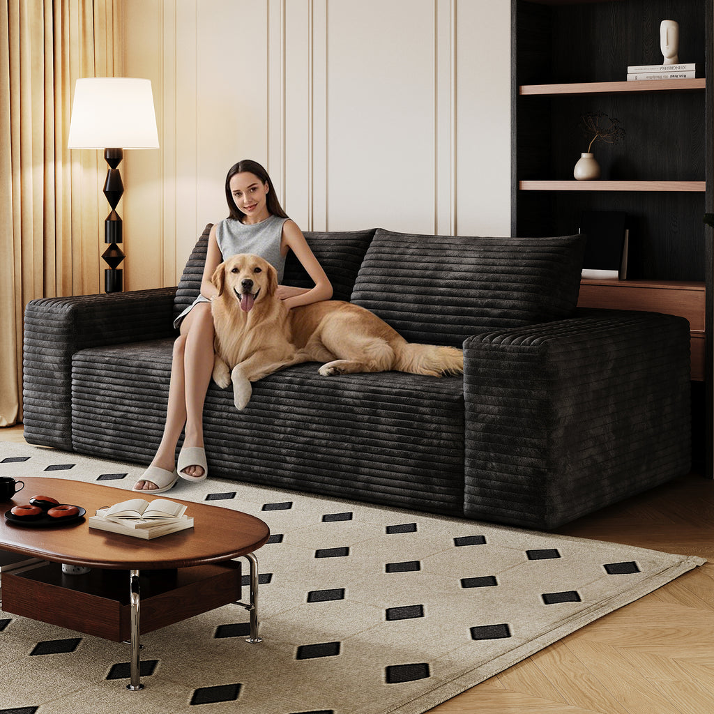 Black corduroy 2-seater sofa in living room setting