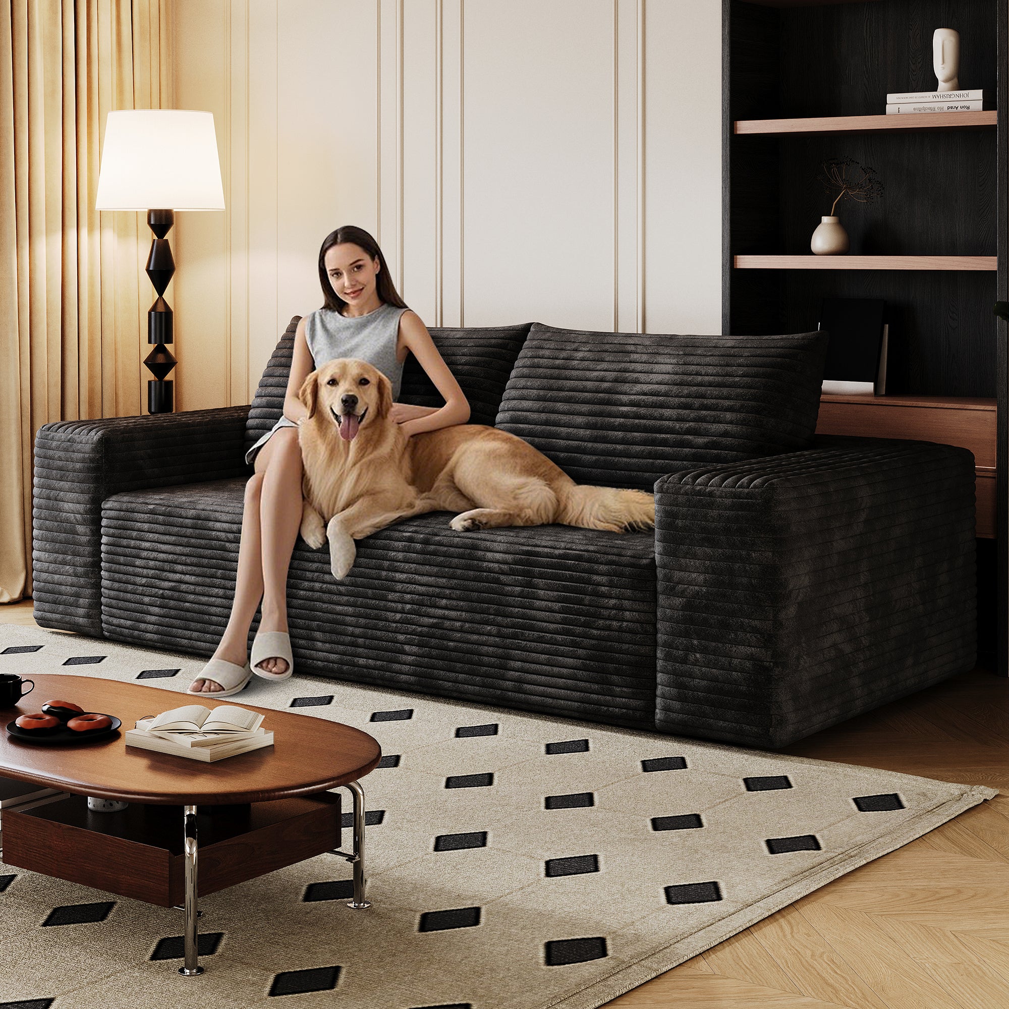 Black corduroy 2-seater sofa in living room setting