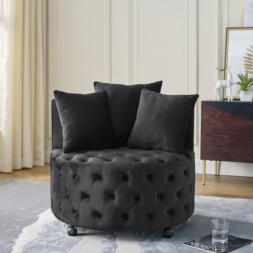 Black velvet tufted swivel chair with 3 pillows in living room