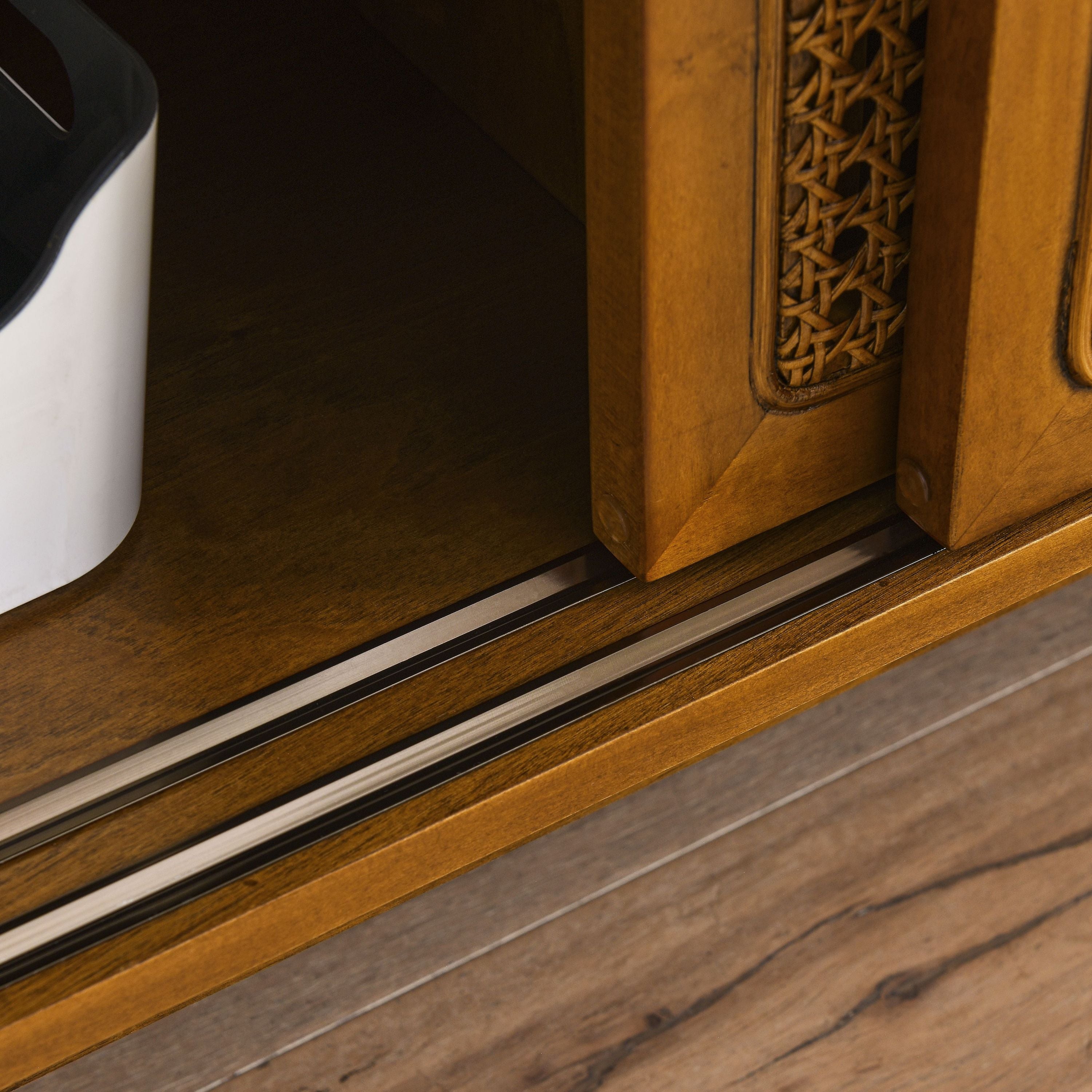 Solid wood leg detail on light wood media console