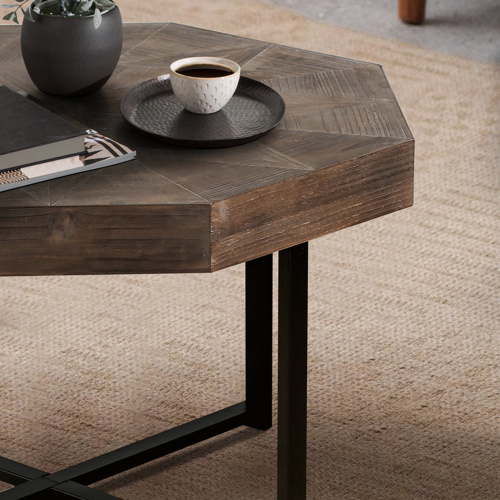 Octagonal coffee table with crossed metal legs — angle view