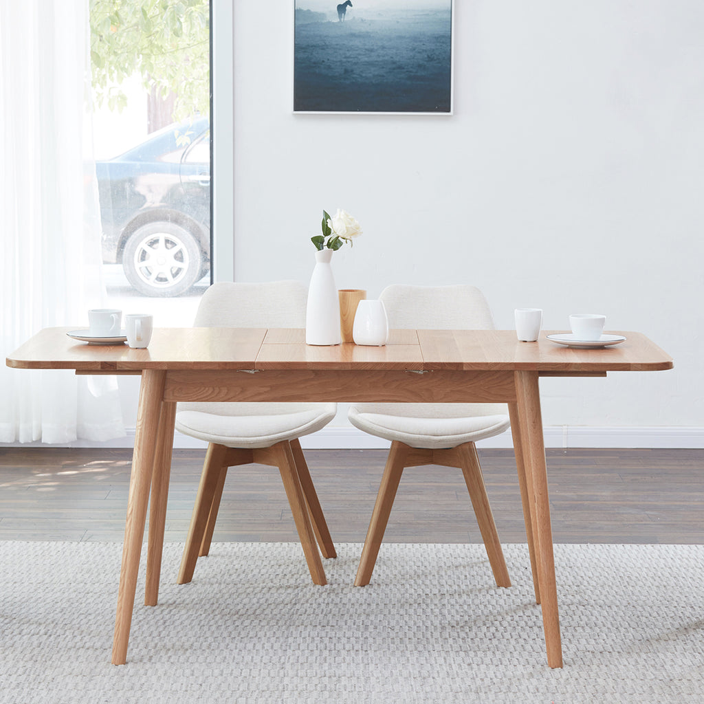 Extendable dining table with round corners and diagonal legs overview