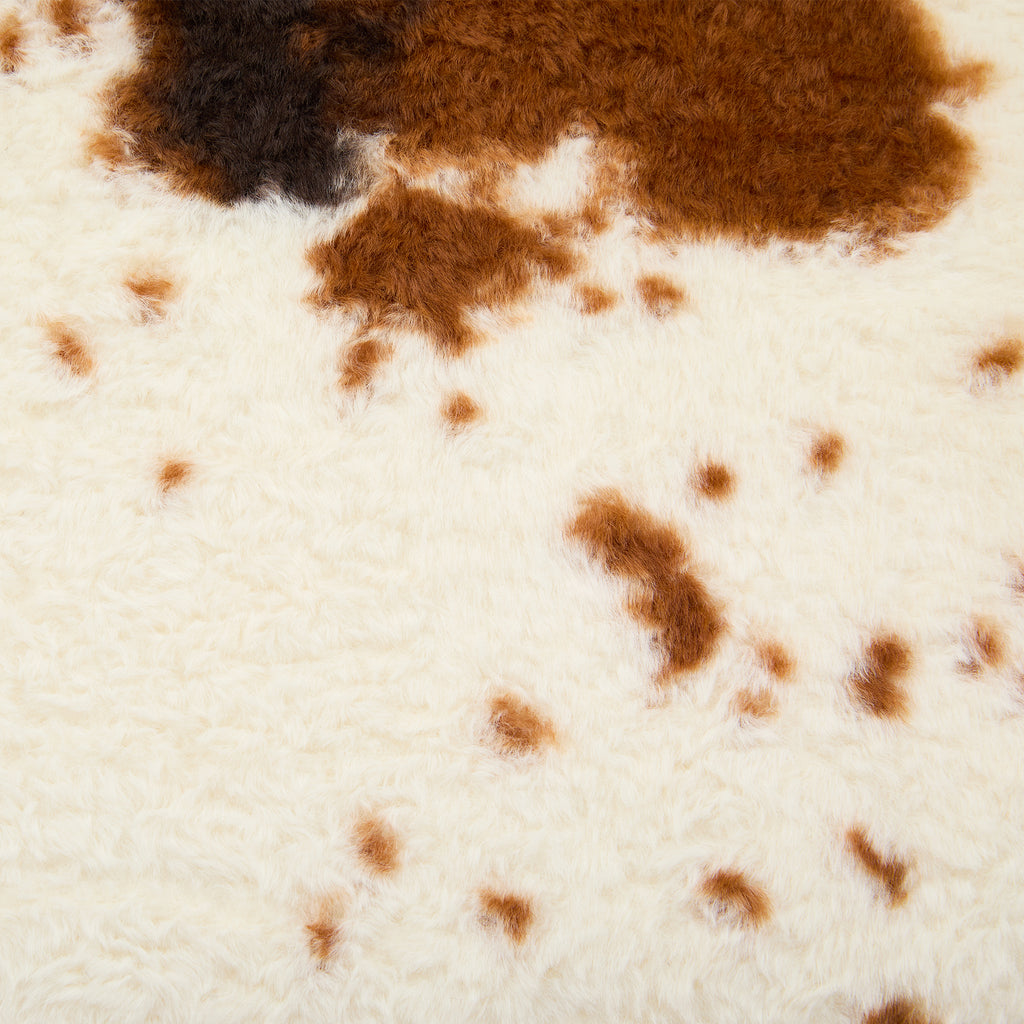 Beige brown faux fur upholstery close-up texture