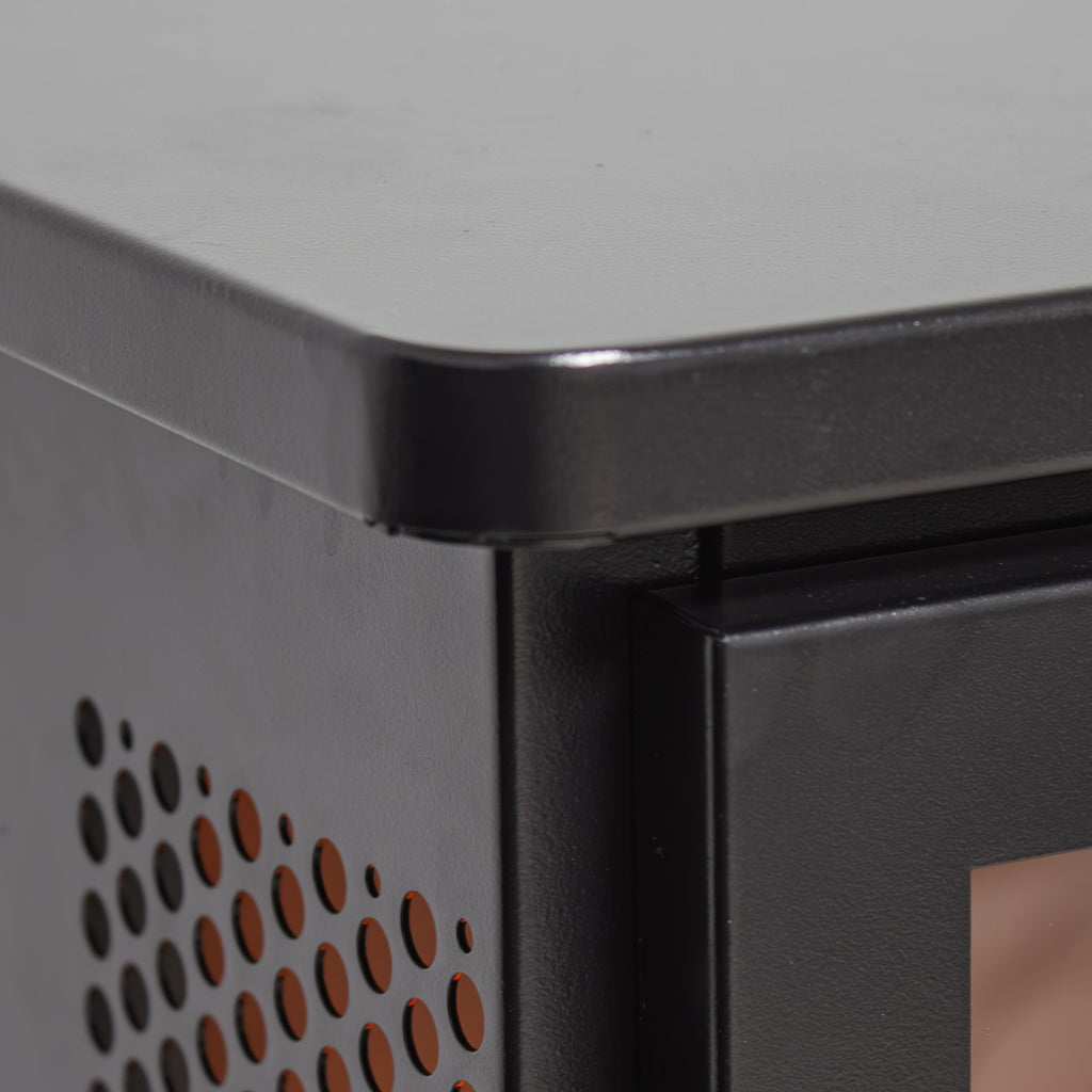 Black electric fireplace stove perforated metal side panel close-up