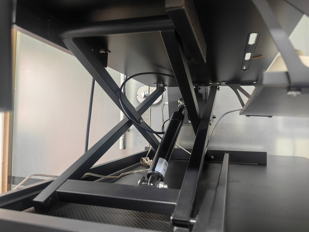 Black standing desk converter in compact study room setting