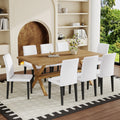 Table and chair set. 71 * 35.4 inch Wood grain MDF splicing desktop with X-shaped metal frame dining table.Includes 8 white PU dining chairs With Black Metal Legs.Making it an ideal choice for home.